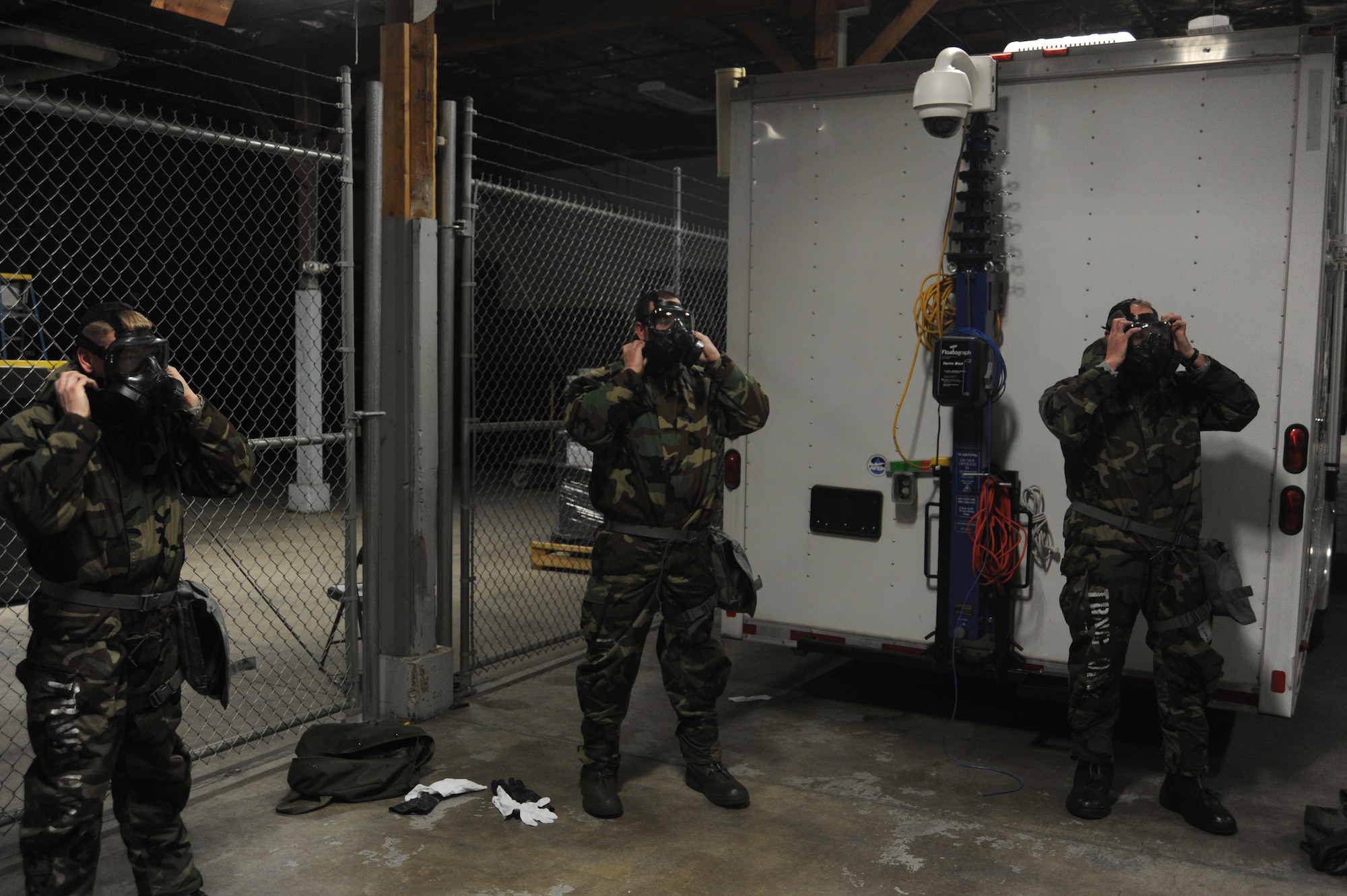 Airmen put on their gas masks at Fairchild Air Force Base, Wash., April 10, 2014.  The masks are an aspect of the Chemical, Biological, Radiological and Nuclear operations training held weekly at the base.  (U.S. Air Force photo by Airman 1st Class Sam Fogleman/Released)