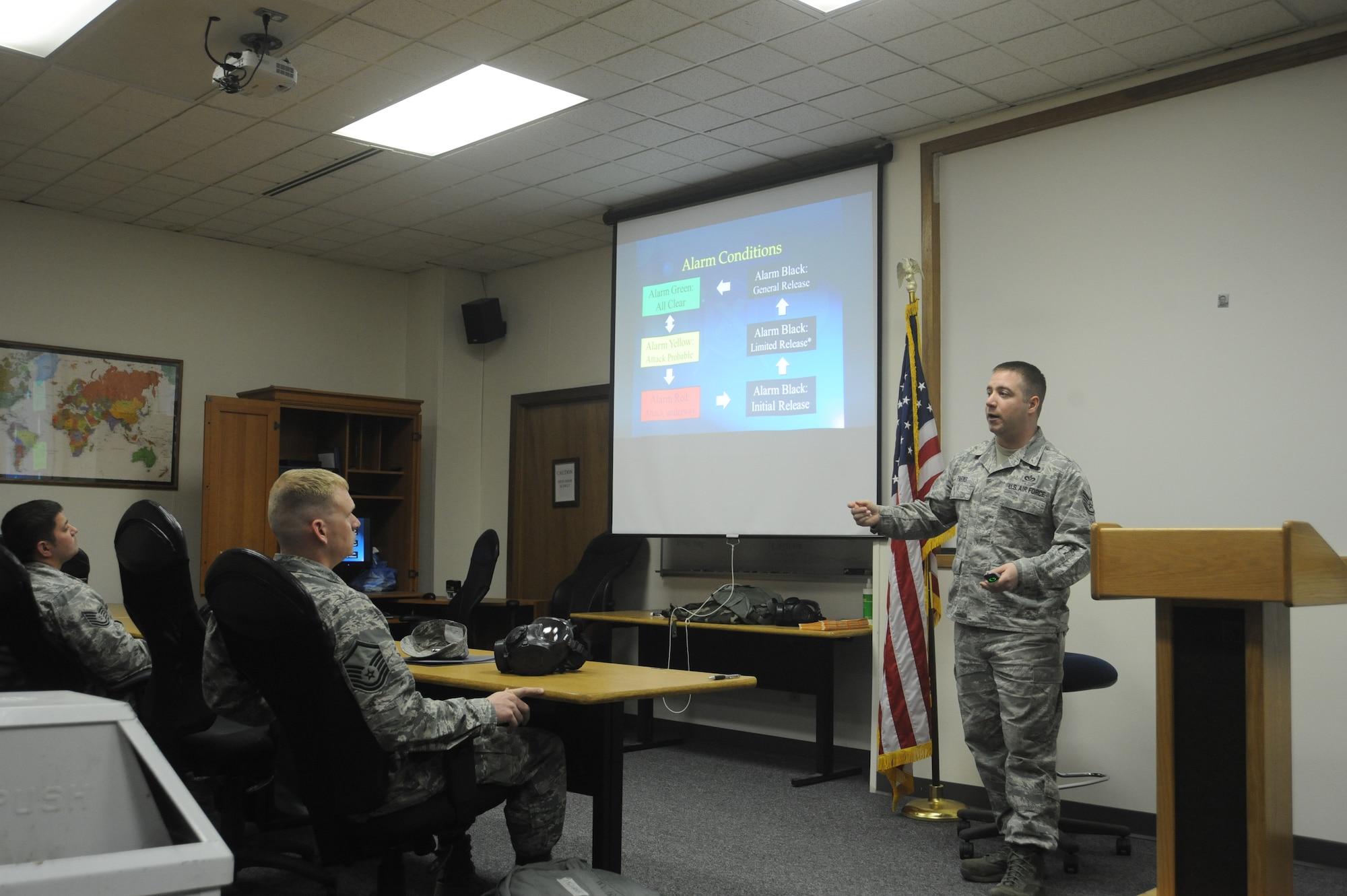 Staff Sgt. Jeremy Parks advises Airmen of alert conditions during Chemical, Biological, Radiological and Nuclear operations training at Fairchild Air Force Base, Wash., April 10, 2014.  The training takes place once per week at the base.  Parks is the 92nd Civil Engineer Squadron emergency management logistics NCO in charge.  (U.S. Air Force photo by Airman 1st Class Sam Fogleman/Released)