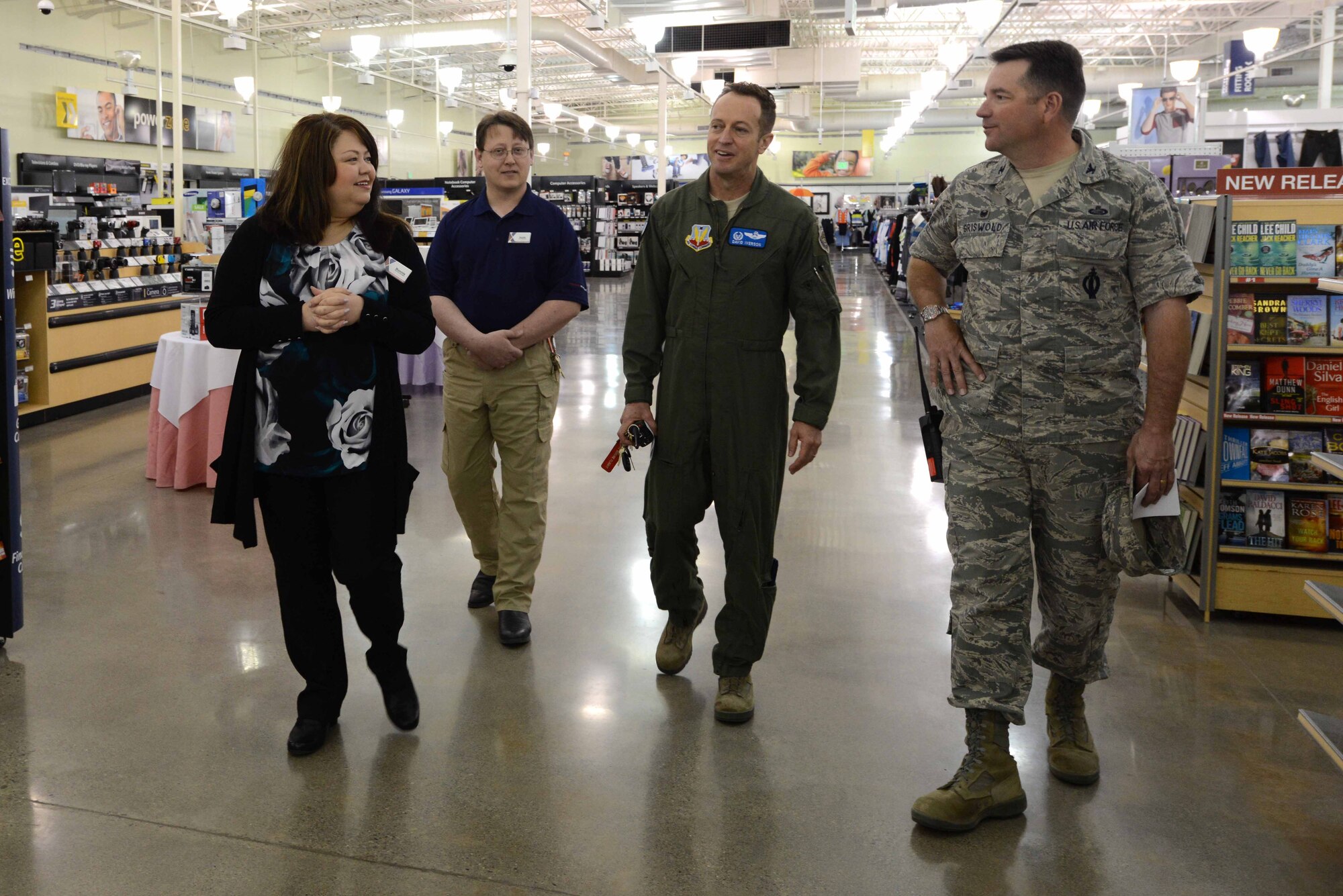 Bonnie Lindahl, Exchange general manager and Keith Gorsuch, Exchange main store manager, escorts Col. Dave Iverson, 366th Fighter Wing commander, and Col. Steven Griswold, 366th Mission Support Group commander through the Mountain Home Air Force Base Exchange, April 11, 2014. Management kept their shopping destination exciting with regular customer contests and prizes, ranging from gift cards to trips. (U.S. Air Force photo by Senior Airman Caitlin Guinazu/RELEASED)