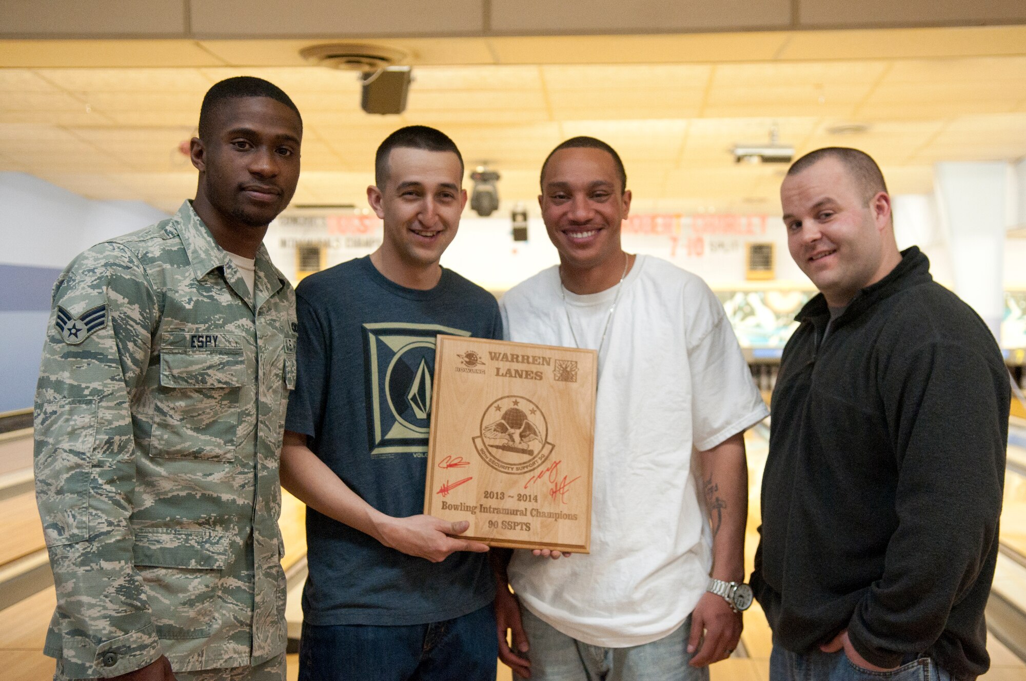 Senior Airman Wendell Espy, Staff Sgt. Cristian Jimenez, Staff Sgt. Michael Jones and Staff Sgt. Anthony Komara, four of the 10 member of the 90th Security Support Squadron bowling team, hold the 2013-2014 intramural bowling championship plaque in Warren Lanes on F.E. Warren Air Force Base, Wyo., March 9. The 90th SSPTS bowling team won the 25-week long intramural bowling tournament. Matches were played every Wednesday, for a max of eight points a night. The 90th SSPTS won with an overall of 124. The 90th Logistics Readiness Squadron bowling team was only two points behind with a total of 122 points. (U.S. Air Force photo by Airman Malcolm Mayfield)