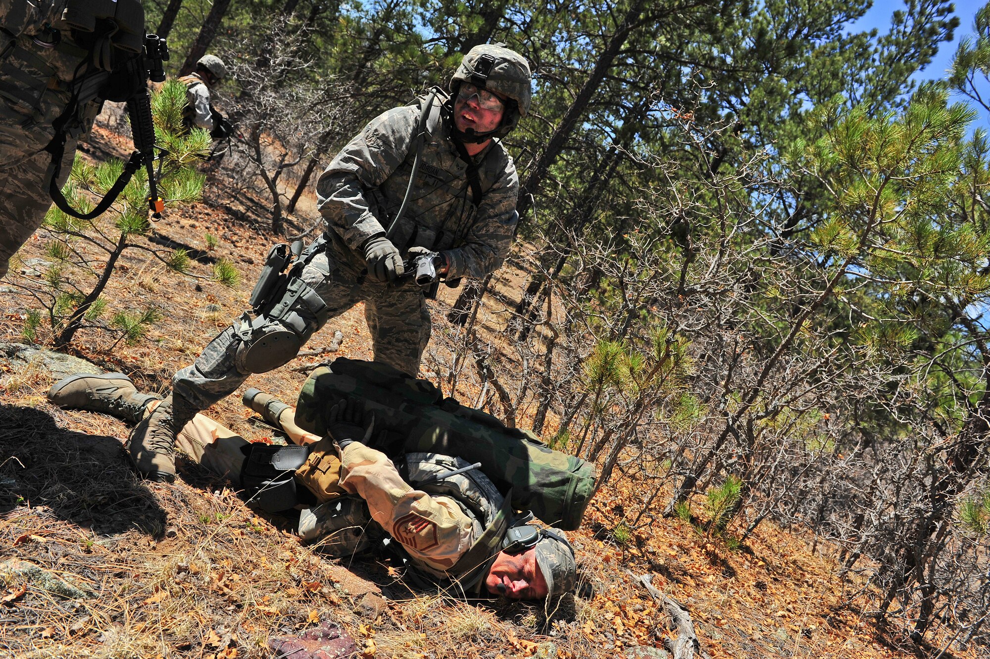 Air Force Reserve Senior Airman Kurt Jordan quickly searches simulated enemy remains for weapons and items of importance during an ambush April 10, 2014, at the U.S. Air Force Academy in Colorado Springs, Colo. The 710th and 310th Security Forces Squadrons held a six-day combat leaders course while living in field conditions. Each day’s mission is designed around the main objective of the day’s classroom instruction, placing practical application of combat maneuvers into complex mission environments. The 710th SFS is out of Buckley Air Force Base, Colo., and the 310th SFS is out of Schriever AFB. (U.S. Air Force photo/Tech. Sgt. Nicholas B. Ontiveros)