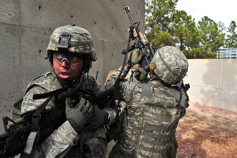 Air Force Reserve Senior Airman Kurt Jordan (left) provides rear protection against potential enemy surprises during a compound raid April 9, 2014, at the U.S. Air Force Academy in Colorado Springs, Colo. The 710th and 310th Security Forces Squadrons held a six-day combat leaders course while living in field conditions. Each day’s mission is designed around the main objective of the day’s classroom instruction, placing practical application of combat maneuvers into complex mission environments. The 710th SFS is out of Buckley Air Force Base, Colo., and the 310th SFS is out of Schriever AFB. (U.S. Air Force photo/Tech. Sgt. Nicholas B. Ontiveros)