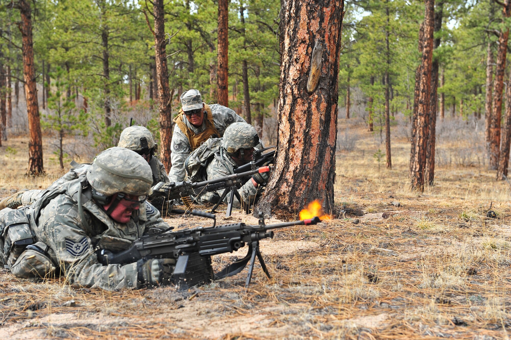 Air Force Reservists Tech. Sgt. Matthew Scandrol aggressively fires at an enemy compound during a training mission while Tech. Sgt. Benjamin Hathoway overlooks the mission April 9, 2014, at the U.S. Air Force Academy in Colorado Springs, Colo. The 710th and 310th Security Forces Squadron held a six-day combat leaders course while living in field conditions. Each day’s mission is designed around the main objective of the day’s classroom instruction, placing practical application of combat maneuvers into complex mission environments. The 710th SFS is out of Buckley Air Force Base, Colo., and the 310th SFS is out of Schriever AFB. (U.S. Air Force photo/Tech. Sgt. Nicholas B. Ontiveros)