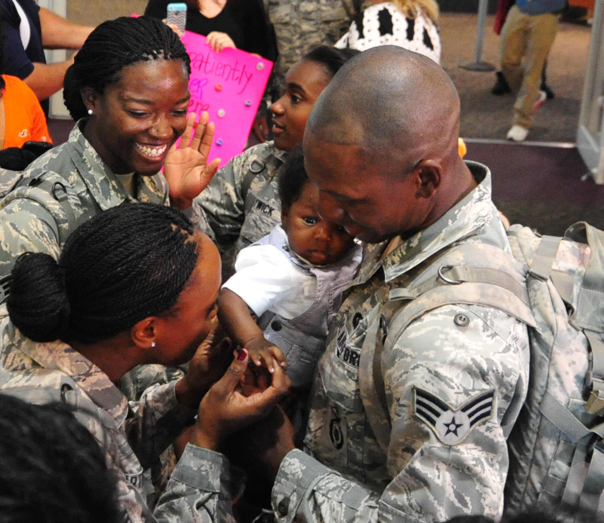 Senior Airman Justin Jackson, holds his son for the first time during a welcome home gathering at the Biloxi-Gulfport International Airport held for 12 403rd Security Forces Squadron deployers who returned after a five-month deployment to Qatar.
