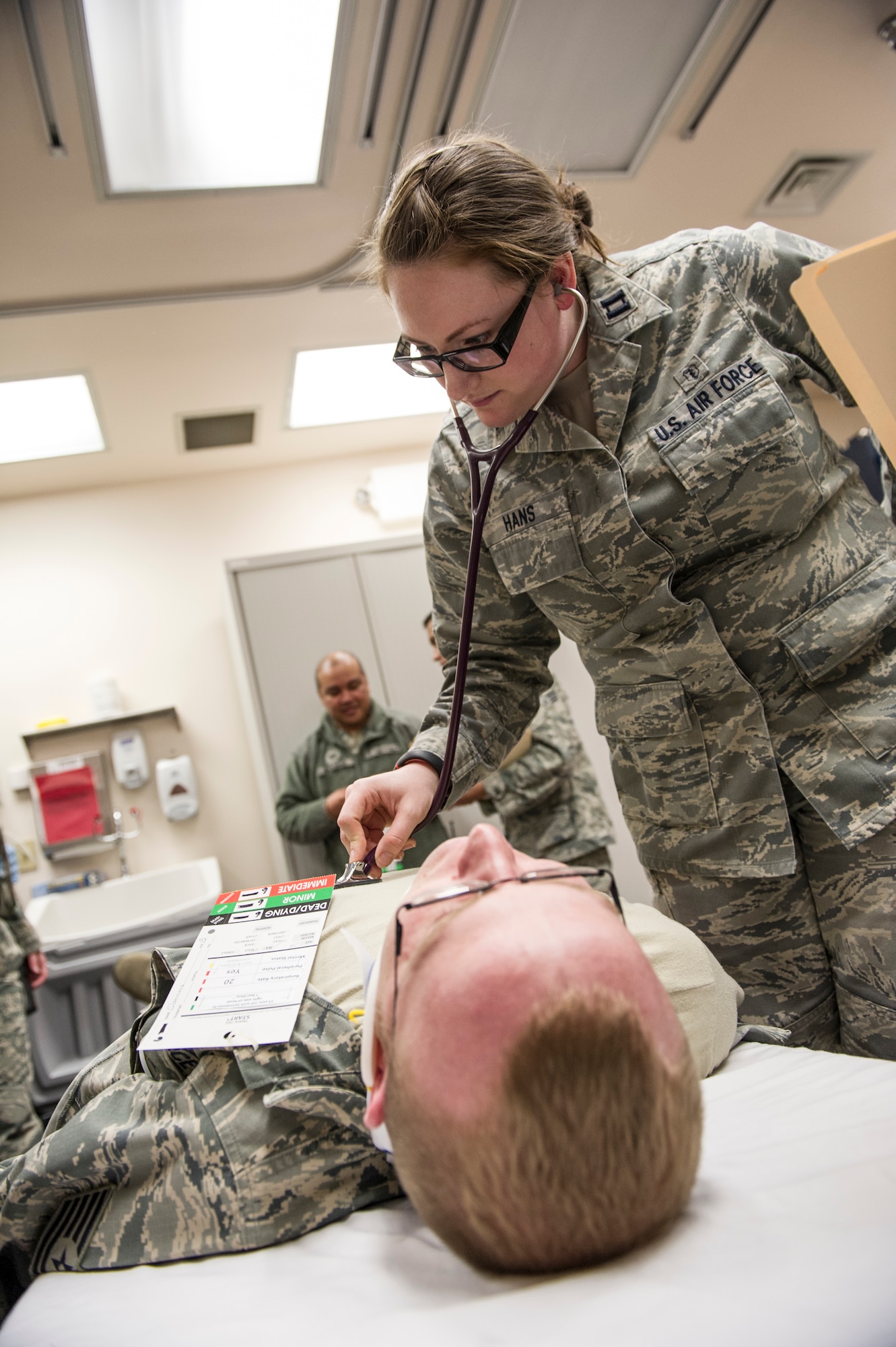 Capt. Nicole Hans, 354th Medical Operations Squadron family practice doctor, checks the vital signs of a simulated victim during a casulty exercise April 1, 2014, Eielson Air Force Base, Alaska. During the exercise, the 354th Medical Group ambulatory services responded and transported simulated juvenille victims to the clinic to be triaged, treated, stabilized and sheltered in place until they were picked up by their parents. (U.S. Air Force photo by Senior Airman Joshua Turner/Released)