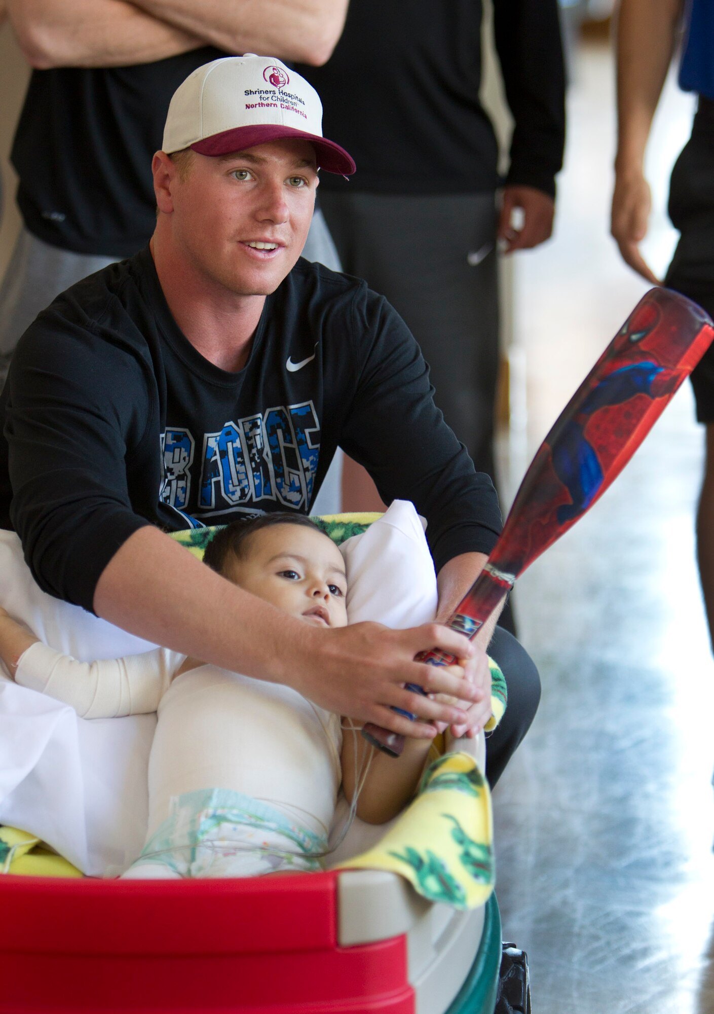 Falcon Baseball pitcher Cameron White puts a toy bat in the hands of a patient at Shriners Hospitals for Children in Sacramento, Calif., March 24. The team visited the hospital March 24 before a warm-up series against the Sacramento State Hornets. (Courtesy photo)