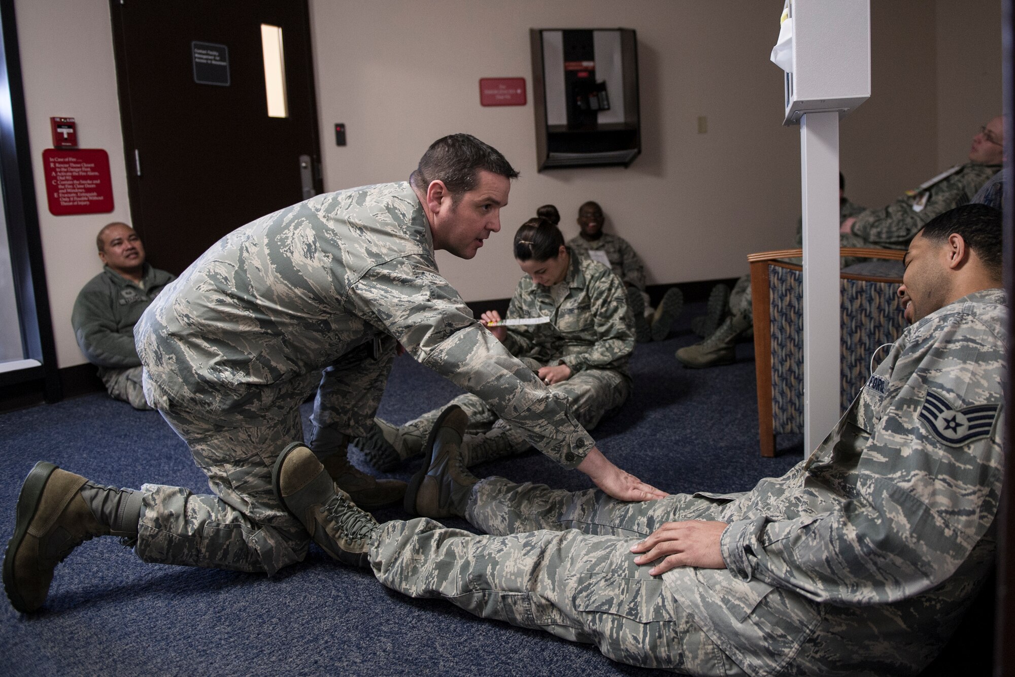 1st Lt. Steven Miresse, 354th Medical Operations Squadron nurse, asseses a simulated victim during a casulty exercise April 1, 2014, Eielson Air Force Base, Alaska. The exercise scenerio involved a school bus accident caused by deteriorating weather conditions. (U.S. Air Force photo by Senior Airman Joshua Turner/Released)
