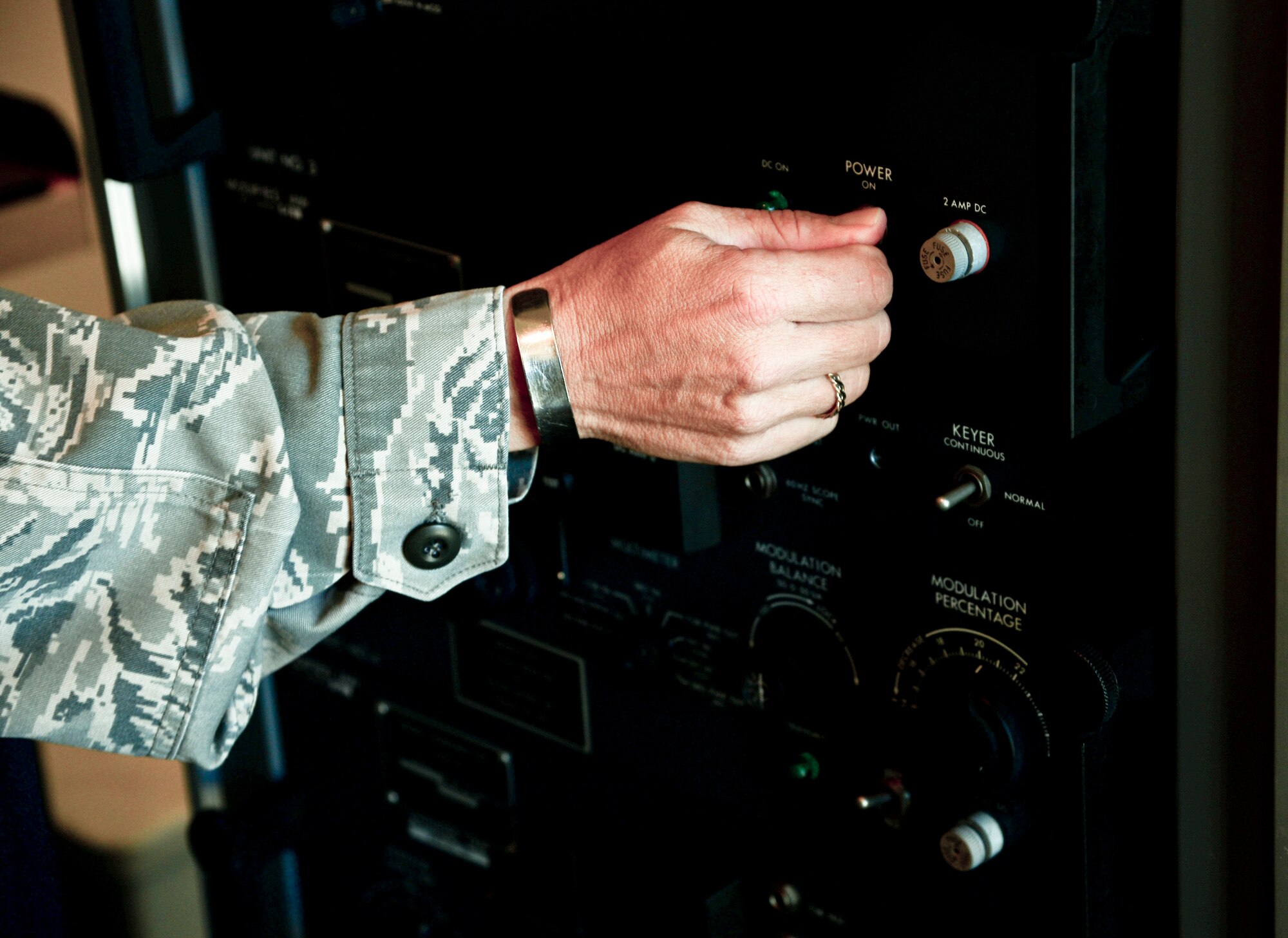Lt. Col. Marlyce Roth, 6th Communications Squadron commander, turns off the power to the old instrumental landing systems equipment, April 11, 2014 at MacDill Air Force Base, Fla. The ILS is used by pilots to assist them in landing duirng limited visibility. (U.S. Air Force photo by Senior Airman Jenay Randolph/Released)
