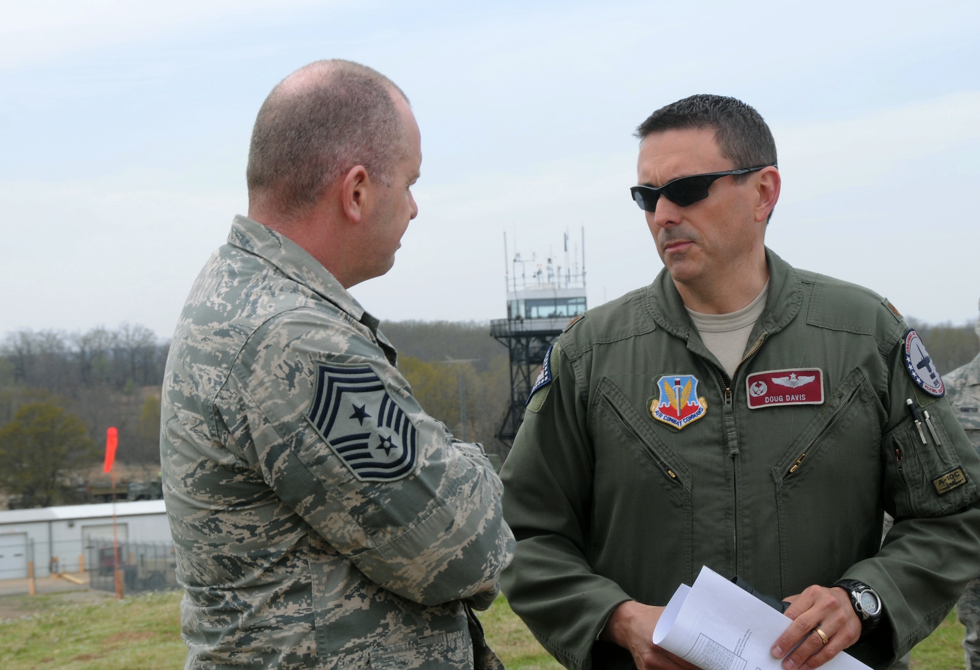 Air National Guard Command Chief Master Sgt. James W. Hotaling speaks with Maj. Doug Davis, 188th Fighter Wing Detachment 1 Razorback Range commander, during his visit to the 188th Fighter Wing April 5, 2014. Hotaling spoke with enlisted Airmen across the base about professionalism, resilience and recognition, and observed close air support training at the range. (U.S. Air National Guard photo by Senior Airman John Hillier/released)