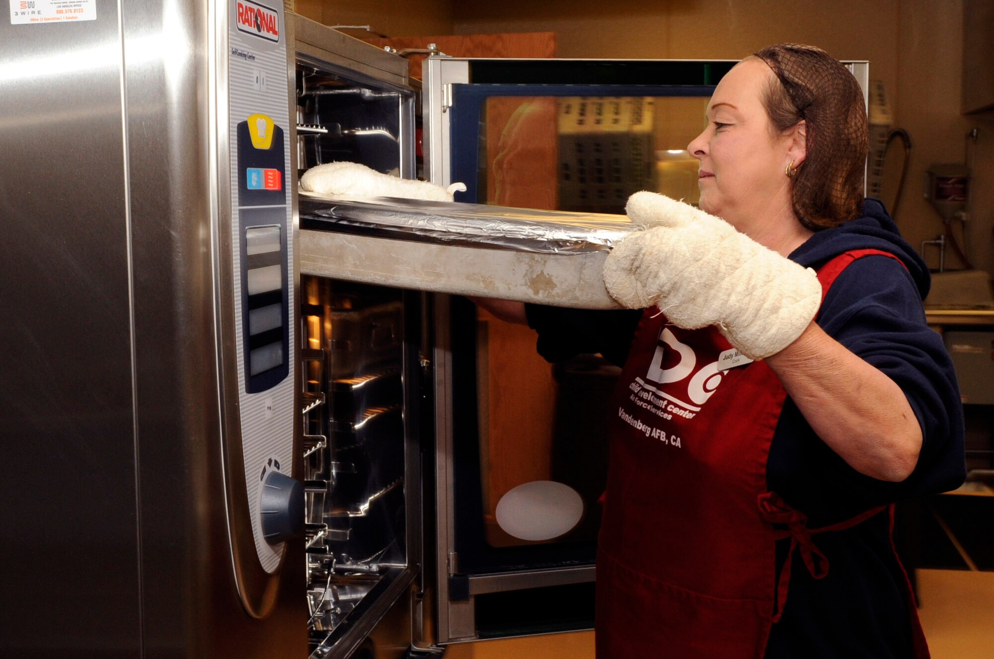 Judy Mitchell, 30th Force Support Squadron Child Development Center lead cook, prepares a meal, April 9, 2014, Vandenberg Air Force Base, Calif. Mitchell has been dedicated to the welfare of children for more than 30 years – and wouldn’t have it any other way. (U.S. Air Force photo/ Senior Airman Shane Phipps)