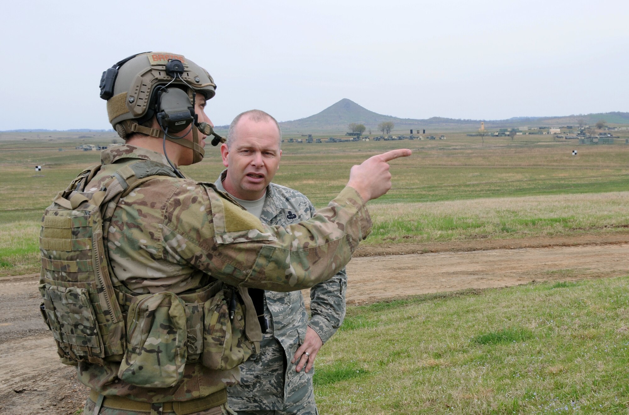 Air National Guard Command Chief Master Sgt. James W. Hotaling speaks with a joint terminal attack controller from the 22nd Special Tactics Squadron during a visit to the 188th Fighter Wing's Detachment 1 Razorback Range April 5, 2014. Hotaling, a former combat controller, met with JTACs to understand the unique training opportunities available at Razorback Range. The 188th’s pilots regularly train with Special Forces JTACs from the U.S. Army Rangers, Air Force Special Operations and Naval Special Warfare teams. (U.S. Air National Guard photo by Senior Airman John Hillier/released)