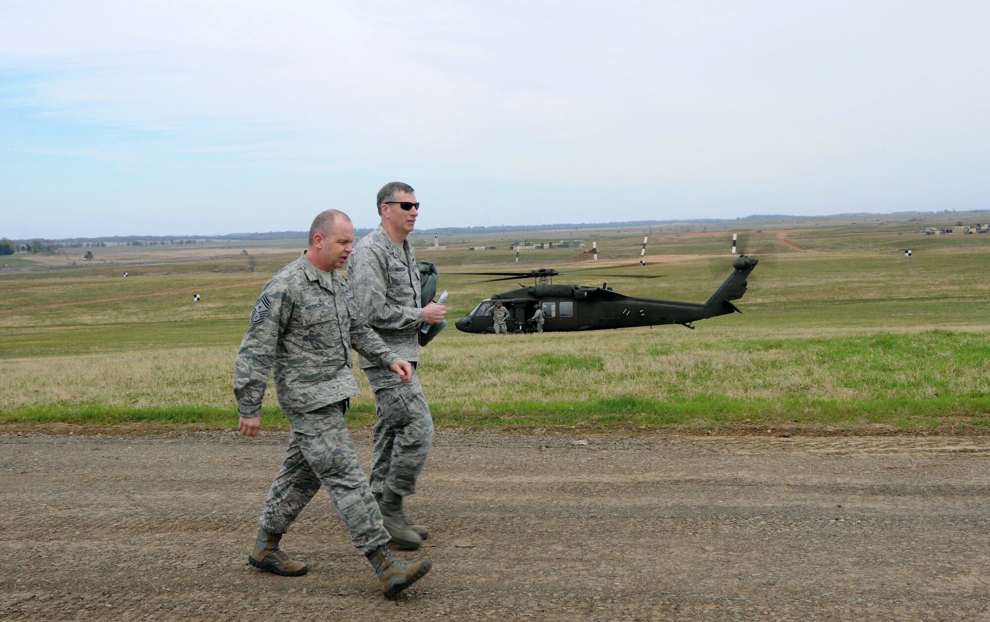 Col. Mark W. Anderson, 188th Fighter Wing commander, right, gives Air National Guard Command Chief Master Sgt. James W. Hotaling a tour of the wing's Detachment 1 Razorback Range April 5, 2014. Hotaling visited the 188th during a unit training assembly and spoke with enlisted Airmen across the base about professionalism, resilience and recognition, as well as heard their concerns about issues in the service. (U.S. Air National Guard photo by Senior Airman John Hillier/released)