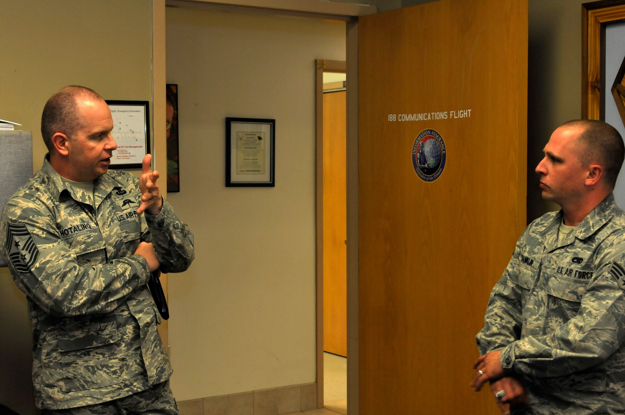Air National Guard Command Chief Master Sgt. James W. Hotaling speaks with Senior Airman Christopher Franklin at Ebbing Air National Guard Base, Fort Smith, Ark., April 5, 2014. Hotaling visited with many different groups of Airmen during his time at the wing. He also met with wing leadership before touring the unit’s facilities.  (U.S. Air National Guard photo by Airman 1st Class Cody Martin/Released)