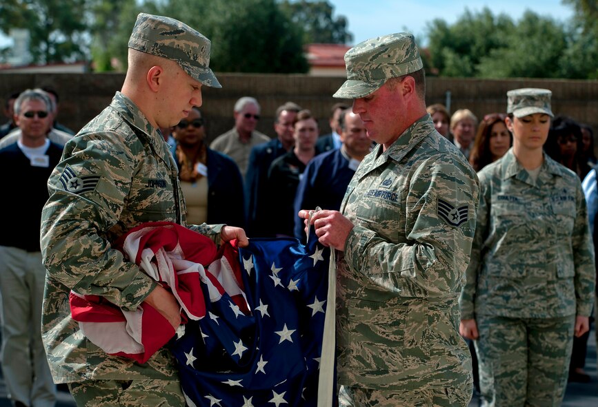 Staff sergeants Devin Johnson, Kevin McDaniel and Lauren Coulter, Professional Military Education instructors at Airmen Leadership School, demonstrate retreat protocol as part of the Honorary Commander Boot Camp, April 3. (U.S. Air Force photo/Tech. Sgt. Matthew Hannen)