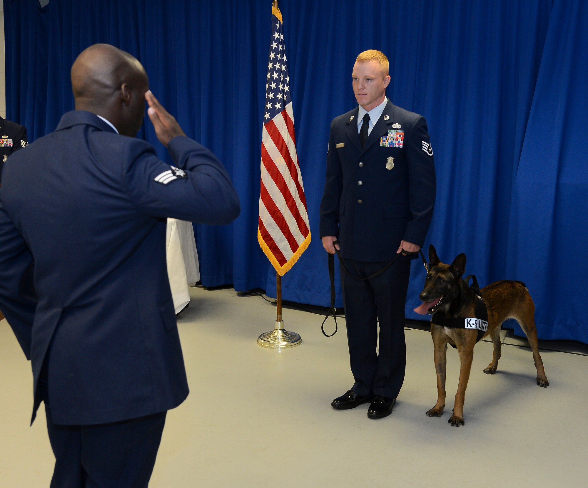 Current and former military working dog handlers of the 6th Security Forces Squadron render a final salute to retired MWD Eddie during Eddie’s retirement ceremony at MacDill Air Force Base, Fla., April 11, 2014. MWD Eddie retired with full ceremonial honors. (U.S. Air Force photo by Senior Airman Shandresha Mitchell/ Released)