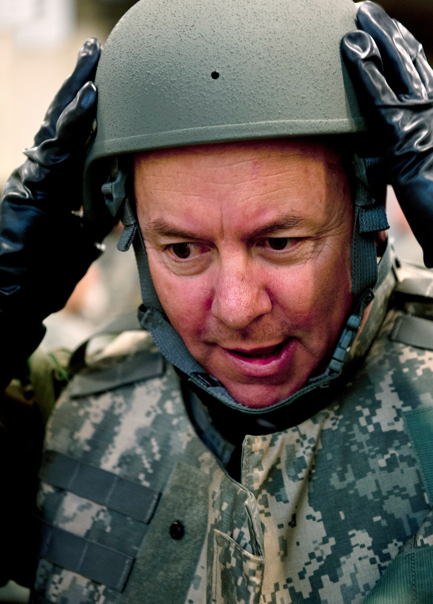 John Dunbar, 60th Maintenance Group Honorary Commander, puts on an advanced combat helmet during a mock deployment line at deployment readiness center as part of the Honorary Commander Boot Camp, April 3. (U.S. Air Force photo/Tech. Sgt. Matthew Hannen)