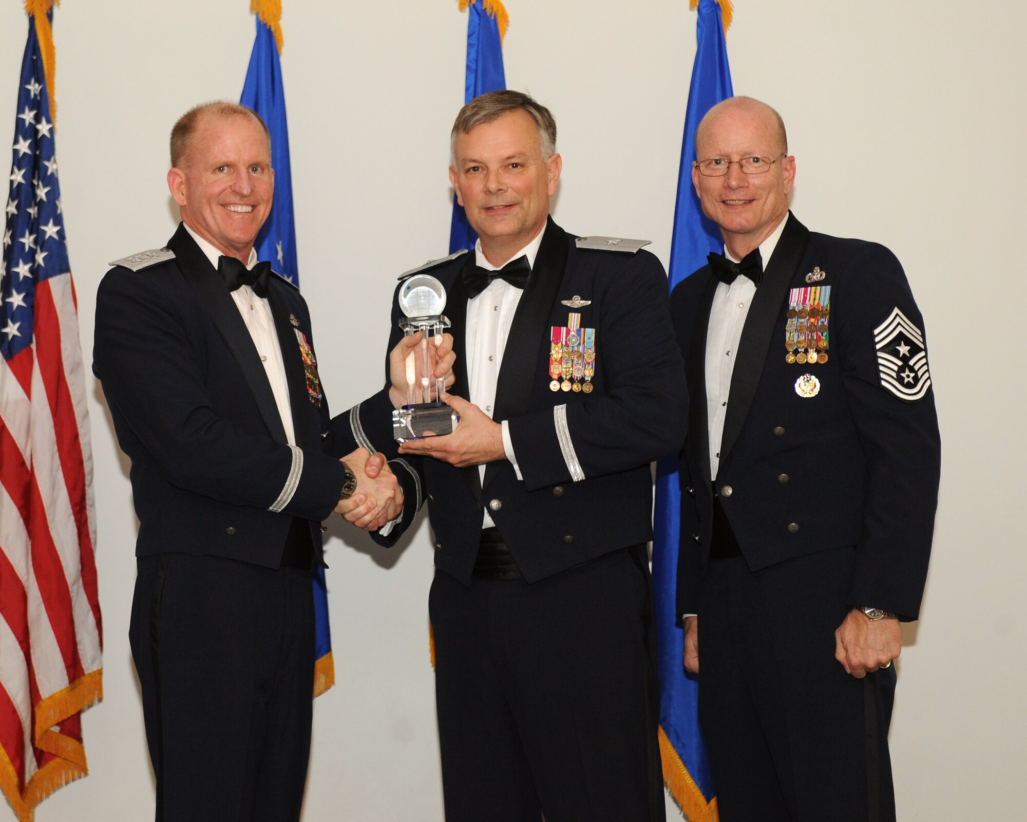 Lt. Gen. Stephen Wilson, commander, Air Force Global Strike Command, and Chief Master Sgt. Terry West, command chief AFGSC, present the Outstanding Noncommissioned Officer of the Year to Brig. Gen. Glen D. VanHerck, 509th Bomb Wing commander, who accepted the award on behalf of Tech. Sgt. Christopher E. Kitts, 509th Operations Support Squadron, Whiteman AFB, Mo. (U.S. Air Force photo by Senior Airman Benjamin Gonsier)