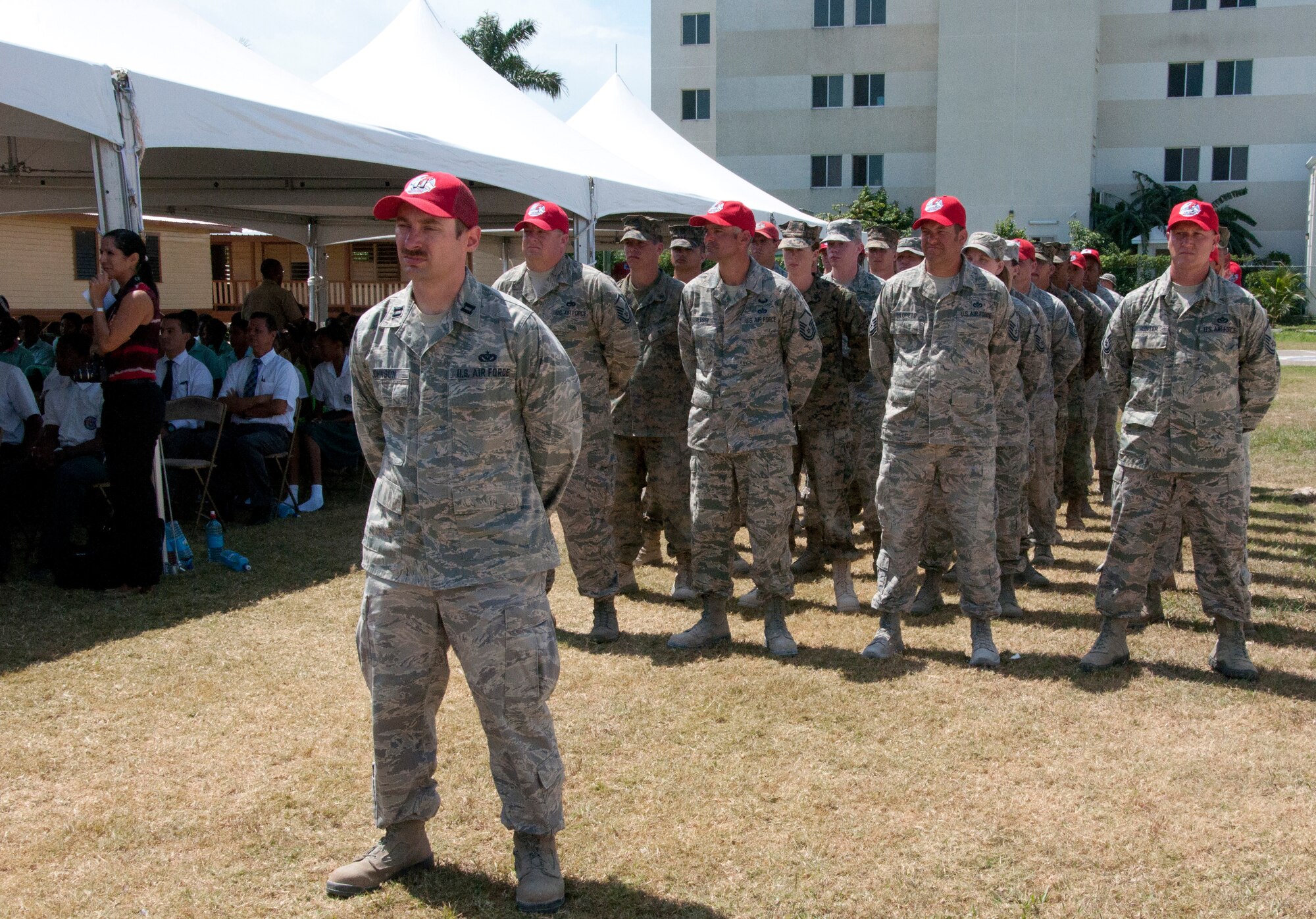 U.S. Air Force and Marine Corps members stand in formation during the New Horizons Belize 2014 opening ceremonies April 10, 2014, at the Edward P. Yorke school in Belize City, Belize. New Horizons is a multifaceted, international exercise comprising Belize Defence Force and U.S. military civil engineers constructing four school facilities and one medical care facility, and it also encompasses numerous medical readiness training exercises throughout the country. Opening ceremonies included presentations by each of the four schools receiving new facilities, as well as speeches from the Belizean minister of education, U.S. Embassy chargé d'affaires and the Hattieville school vice principal. (U.S. Air Force photo by Tech. Sgt. Kali L. Gradishar/Released)


