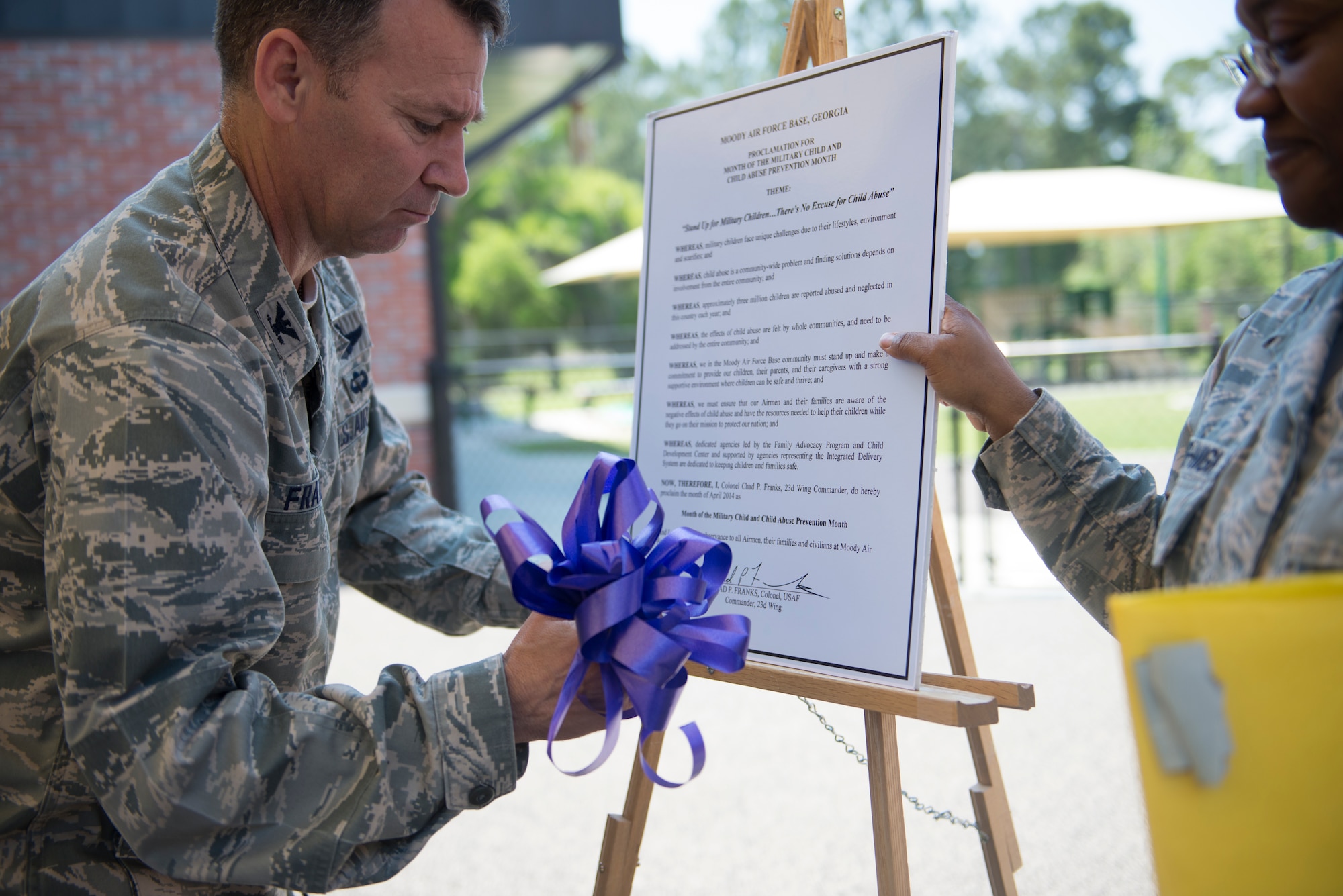 U.S. Air Force Col. Chad Franks, 23d Wing commander, signs a Child Abuse Prevention Proclamation April 9, 2014, at Moody Air Force Base, Ga. April’s Child Abuse Prevention Month raises awareness to Moody and the community on ways to put an end to child abuse. (U.S. Air Force photo by Airman Dillian Bamman/Released)
