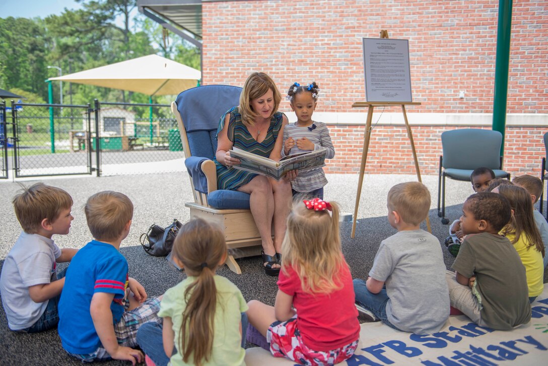 Kim Franks, wife of U.S. Air Force Col. Chad Franks, 23d Wing commander, reads a story to Child Development Center children at a Child Abuse Prevention proclamation signing April 9, 2014, at Moody Air Force Base, Ga. Mrs. Franks read to the children after they finished hand painting a child abuse awareness poster with Col. Franks.
(U.S. Air Force photo by Airman Dillian Bamman/Released)
