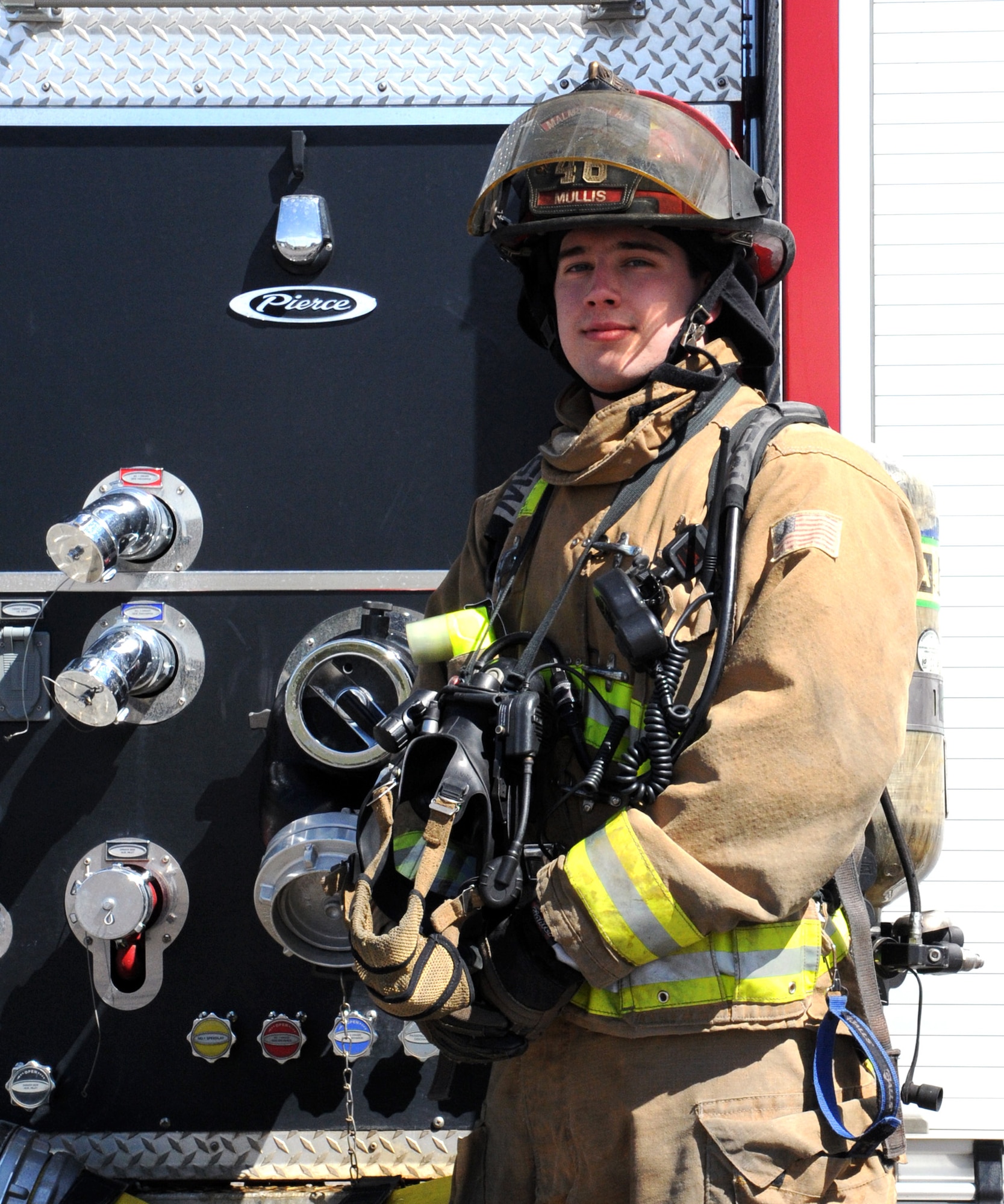 Staff Sgt. Michael Mullis, 341st Civil Engineer Squadron fire protection crew chief, poses in front of a Malmstrom Air Force Base fire truck. Mullis was recently named Air Force Firefighter of the Year. (U.S. Air Force photo/Airman 1st Class Joshua Smoot)