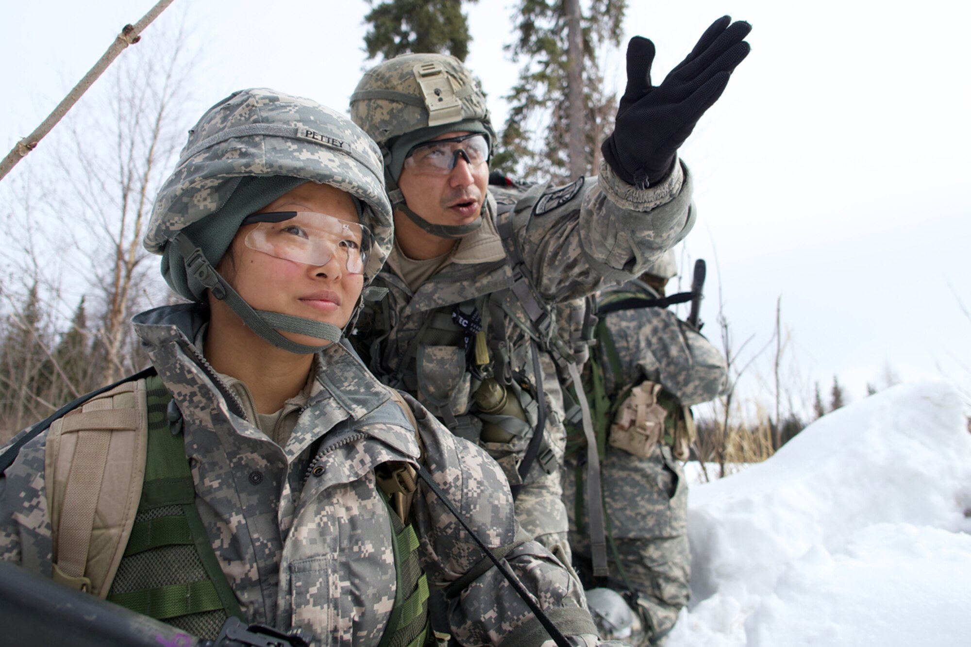 JOINT BASE ELMENDORF-RICHARDSON, Alaska -- Bijesh Shrestha (left), a Army ROTC junior-standing cadet at the University of Alaska Anchorage, assigns a field of fire to Nikki Pettey, a sophomore cadet at UAA April 4 during the University of Alaska Anchorage and UAF Joint Field Training Exercise at JBER's Camp Mad Bull. Army ROTC cadets operate as part of infantry squads and platoons during leadership exercises. (U.S. Air Force photo/David Bedard)