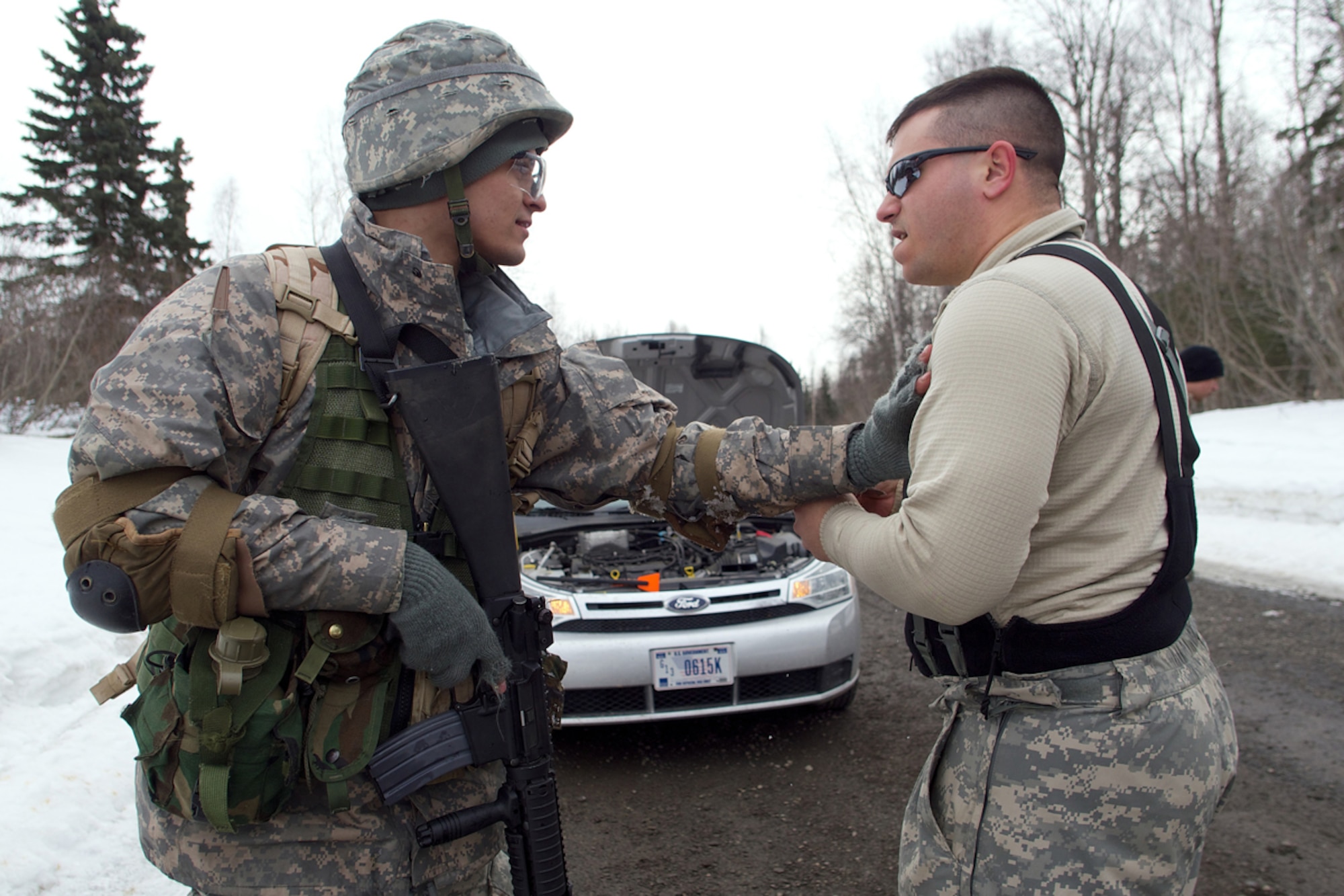 JOINT BASE ELMENDORF-RICHARDSON, Alaska -- Dominick Mariutto, a sophomore Army ROTC cadet at the University of Alaska Fairbanks, attempts to calm a civilian, roleplayed by Spc. Adam Fleischman, 1st Battalion (Airborne), 501st Infantry Regiment, April 4 during the University of Alaska Anchorage and UAF Joint Field Training Exercise at JBER's Camp Mad Bull. Mariutto's squad was expecting to set an ambush for an enemy resupply patrol, but were instead called upon to assist civilians on the battlefield. (U.S. Air Force photo/David Bedard)