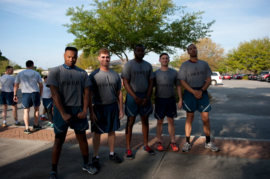 Airmen from the 1st Special Operations Medical Operations Squadron pose for a group photo during the CLEAR Challenge Obstacle Course on Hurlbrut Field, Fla., April 11, 2014. Hurlburt members and their families were encouraged to come out and enjoy a day of morale-boosting and awareness activities. (U.S. Air Force photo/Senior Airman Krystal M. Garrett)