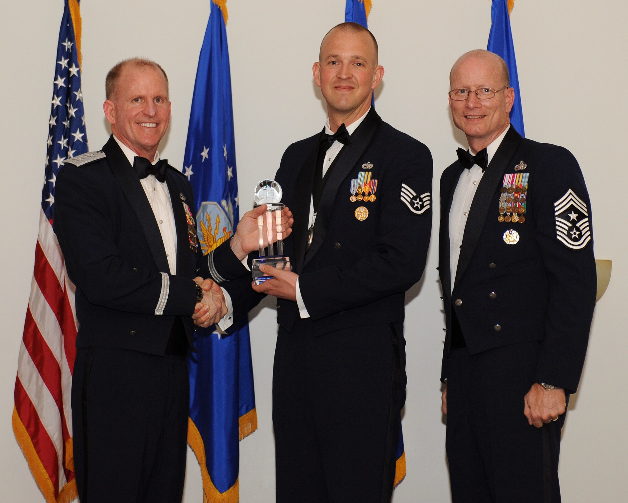 Lt. Gen. Stephen Wilson, commander, Air Force Global Strike Command, and Chief Master Sgt. Terry West, command chief AFGSC, present Staff Sgt. Joshua Hull, 5th Force Support Squadron, Minot Air Force Base, N.D., with AFGSC Outstanding Airman of the Year honors, Honor Guard Program Manager category, at Barksdale AFB, La., April 10. (U.S. Air Force photo by Senior Airman Benjamin Gonsier)
