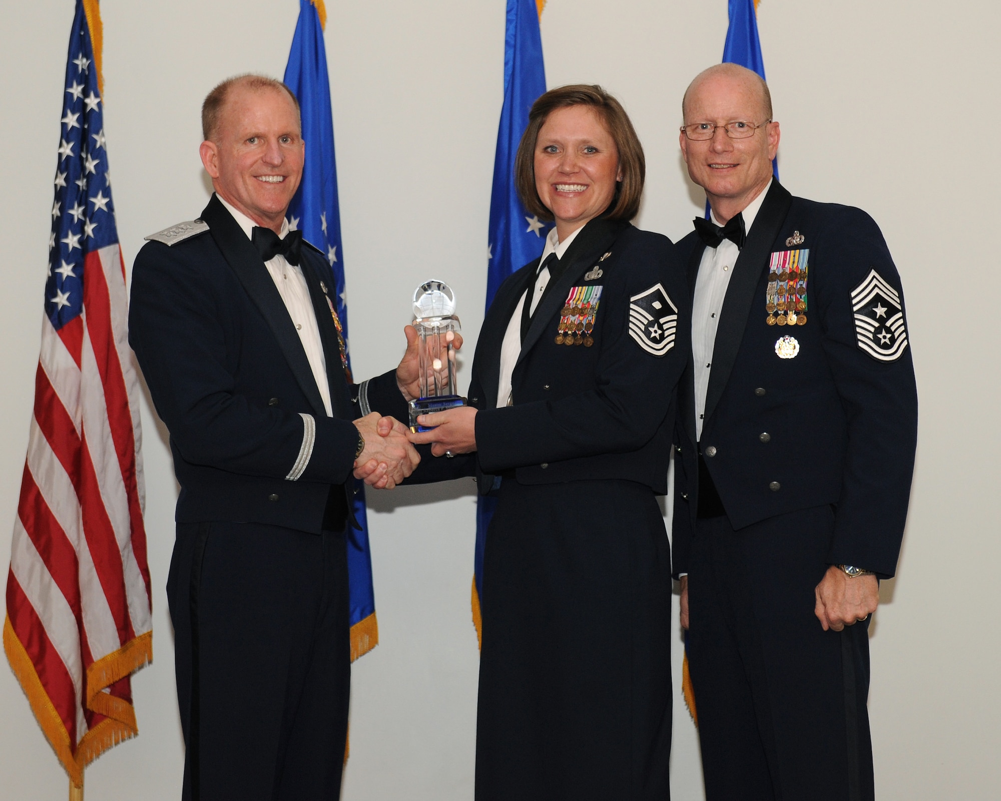 Lt. Gen. Stephen Wilson, commander, Air Force Global Strike Command and Chief Master Sgt. Terry West, command chief AFGSC, present Master Sgt. Rebecca McNelley, 790th Missile Security Forces Squadron, F.E. Warren Air Force Base, Wyo., AFGSC Outstanding Airman of the Year honors, First Sergeant category, at Barksdale AFB, La., April 10. (U.S. Air Force photo by Senior Airman Benjamin Gonsier)