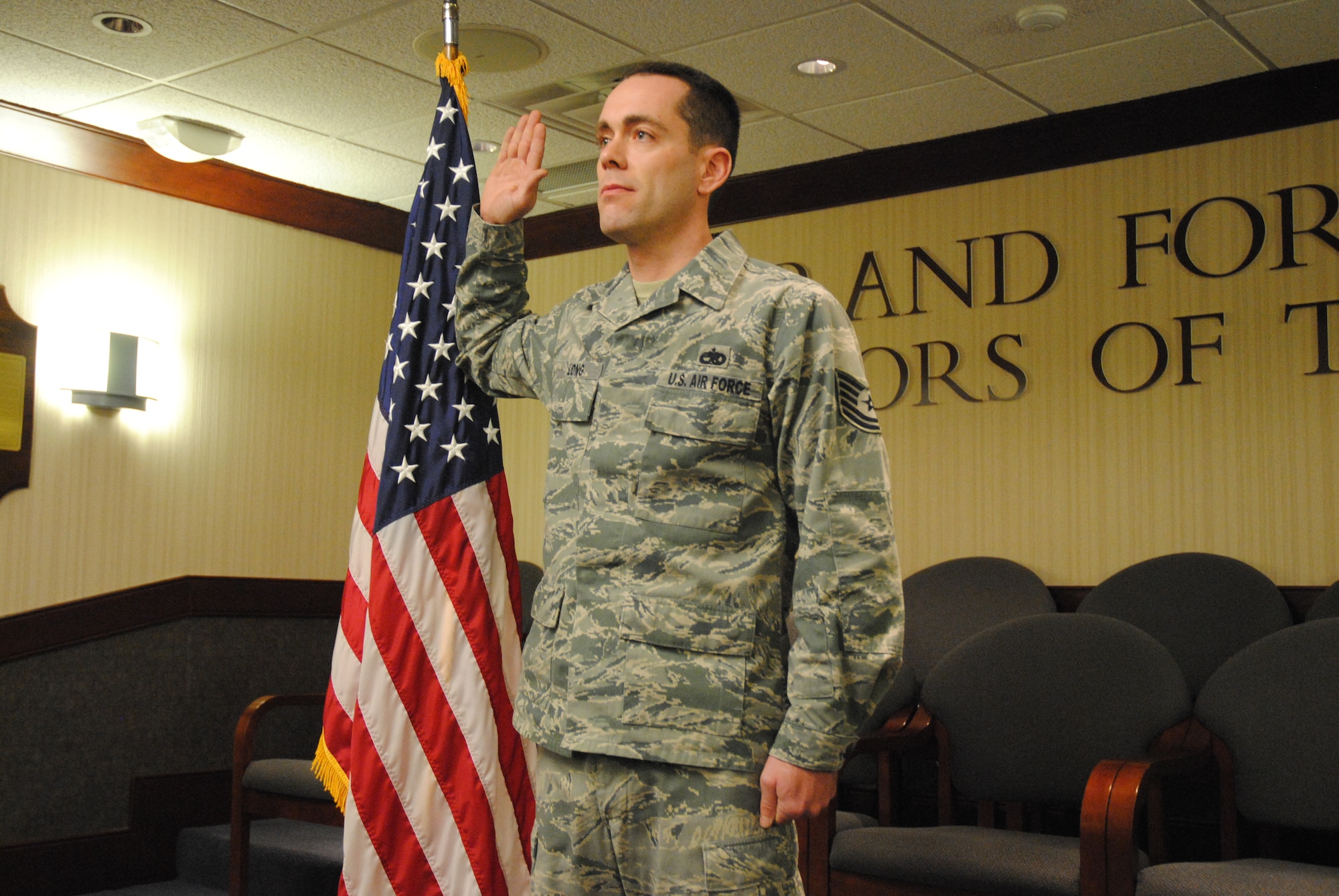 Tech. Sgt. Rick Long Jr., 69th Maintenance Squadron flightline expediter, took the oath of enlistment from his father, retired Air Force Capt. Rick Long Sr., on April 2, 2014, during a reenlistment ceremony digitally broadcast between Grand Forks Air Force Base, N.D. and Wright -Patterson Air Force Base, Ohio. Sergeant Long is an active-duty Airman with more than 11 years of service. (U.S. Air Force photo/Staff Sgt. Luis Loza Gutierrez)