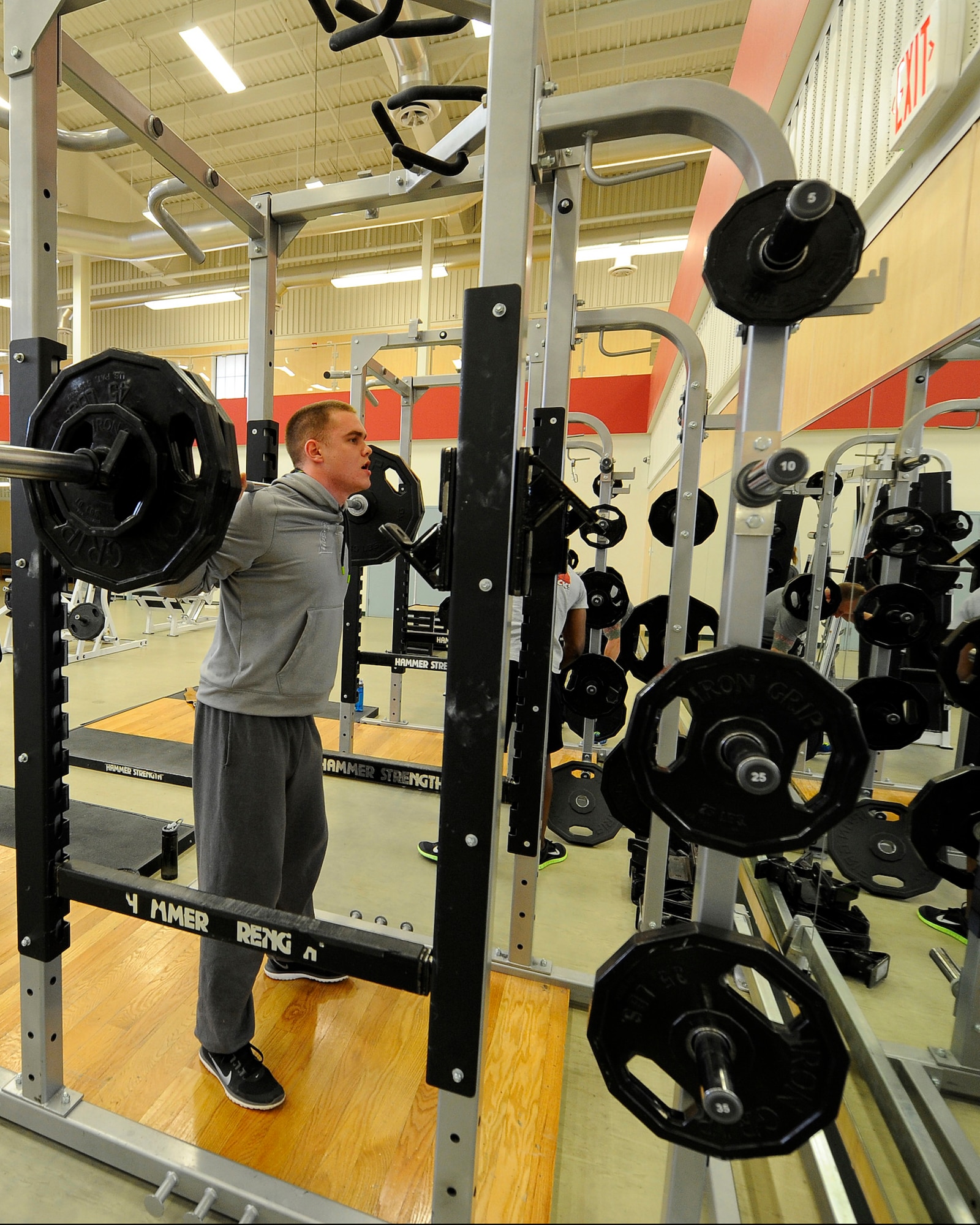 Senior Airman Tanner Olson, 341st Missile Security Forces Squadron member (right), squats more than 200 pounds during a workout session. For weightlifting, Malmstrom’s Fitness Center offers more than 50 different machines and free-weight gear such as dumbbells, kettle bells and plates. (U.S. Air Force photo/Airman 1st Class Collin Schmidt)