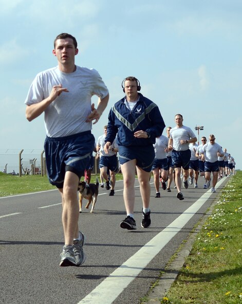 Team Mildenhall members pace each other during the 100th Air Refueling Wing 5 km run April 11, 2014, on RAF Mildenhall, England. Every month, Team Mildenhall members gather for exercise and friendly competition. The run is mandatory for 100th ARW Airmen and open to all Team Mildenhall members. (U.S. Air Force photo by Airman 1st Class Jonathan Light/Released)