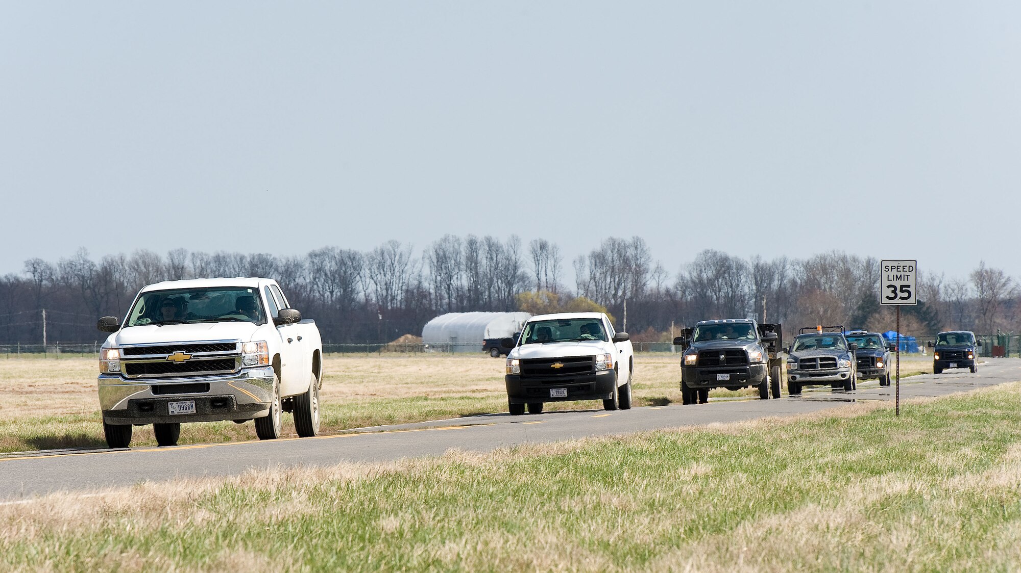 Prime Base Engineer Emergency Forces personnel from the 436th Civil Engineer Squadron drive on Perimeter Road April 9, 2014, near the deployment training area on Dover Air Force Base, Del. Personnel received training on tactical convoy operations to prepare them for world-wide missions. (U.S. Air Force photo/Roland Balik)