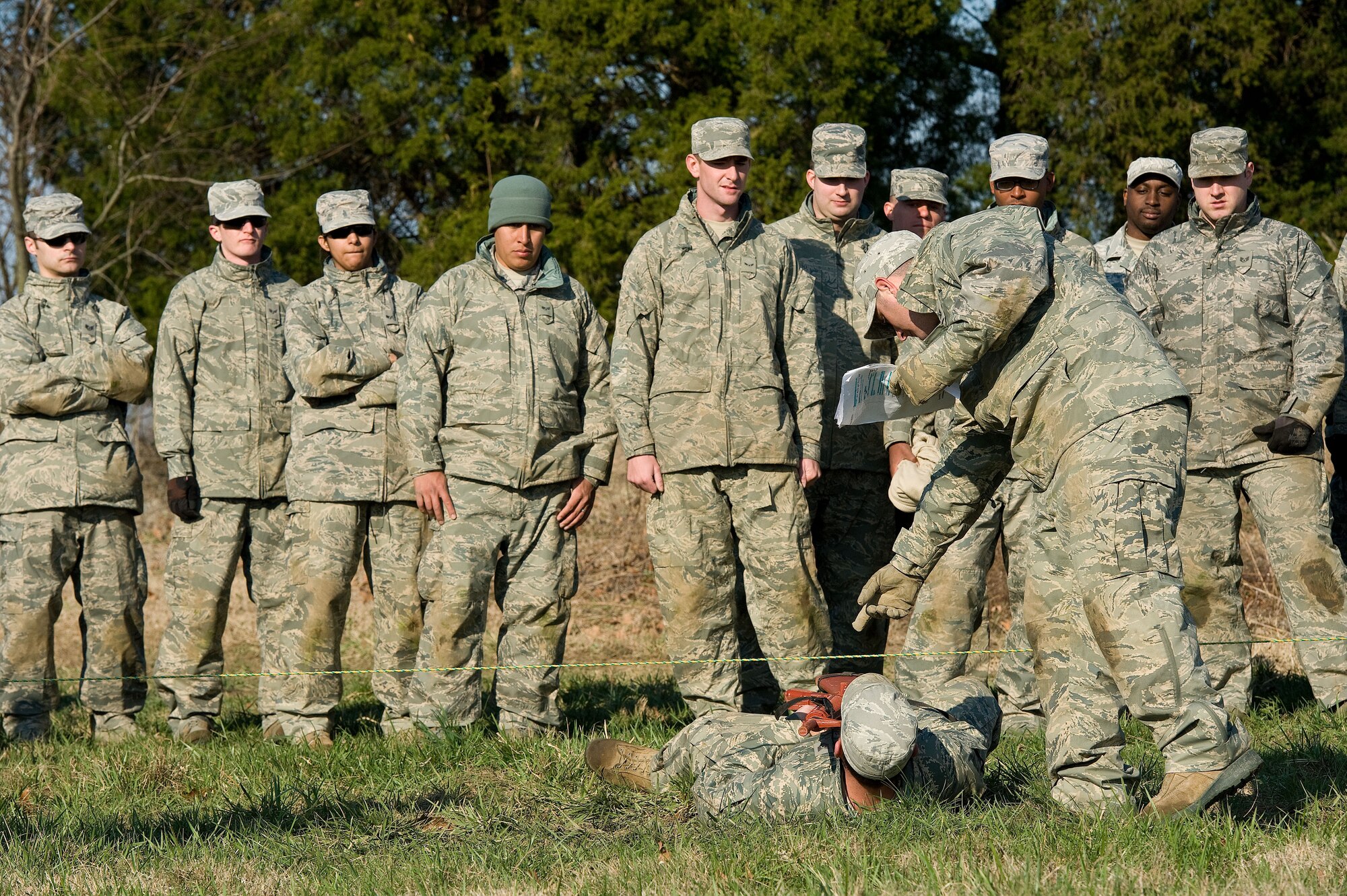 Team Dover members from the 436th Civil Engineer Squadron receive training on maneuvering under simulated concertina wire April 9, 2014, at the deployment training area on Dover Air Force Base, Del. Personnel crawled under simulated concertina wire on their backs while holding a mock M16 rifle. (U.S. Air Force photo/Roland Balik)