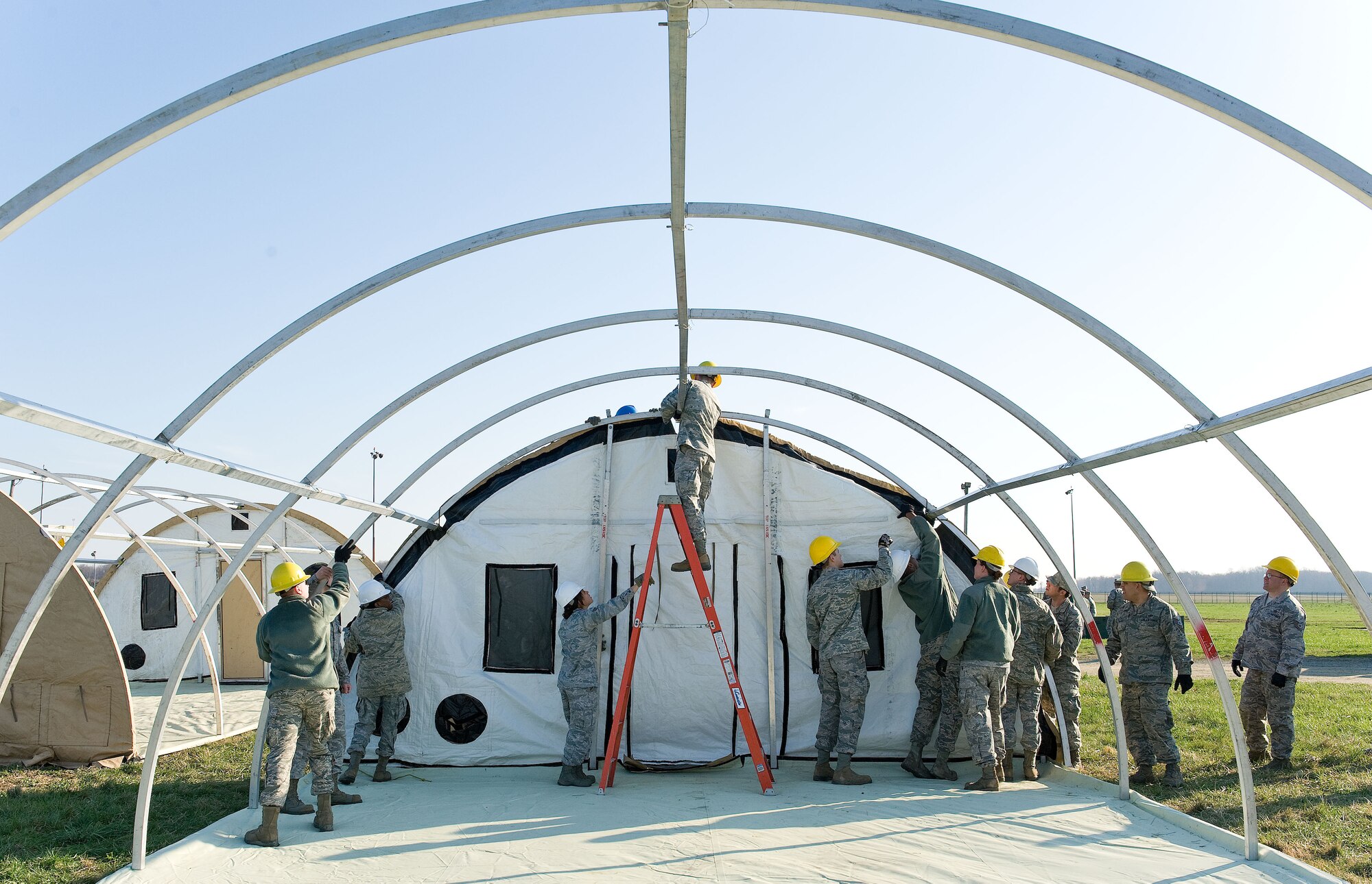Prime Base Engineer Emergency Forces personnel from the 436th Civil Engineer Squadron set up a tent April 9, 2014, at the deployment training area on Dover Air Force Base, Del. Personnel went through three days of training to prepare squadron members for world-wide missions. (U.S. Air Force photo/Roland Balik)