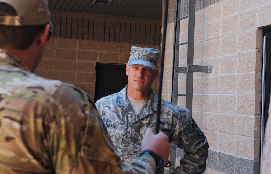 U.S. Air Force Tech. Sgt. Shane Brickey, 38th Rescue Squadron pararescueman, debriefs Chief Master Sgt. Scott Fuller, Ninth Air Force command chief, after a breach and rescue demonstration at Moody Air Force Base, Ga., April 9, 2014. While visiting the 38th RQS, Fuller received a better understanding of what the pararescuemen do while downrange. (U.S. Air Force photo by Senior Airman Olivia Bumpers/Released)