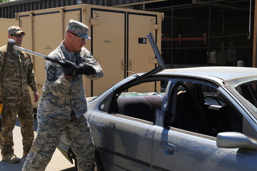 U.S. Air Force Chief Master Sgt. Scott Fuller, Ninth Air Force command chief, uses a sledgehammer at Moody Air Force Base, April 9, 2014. Fuller participated in a breach and rescue demonstration with members of the 38th Rescue Squadron. (U.S. Air Force photo by Senior Airman Olivia Bumpers/Released)
