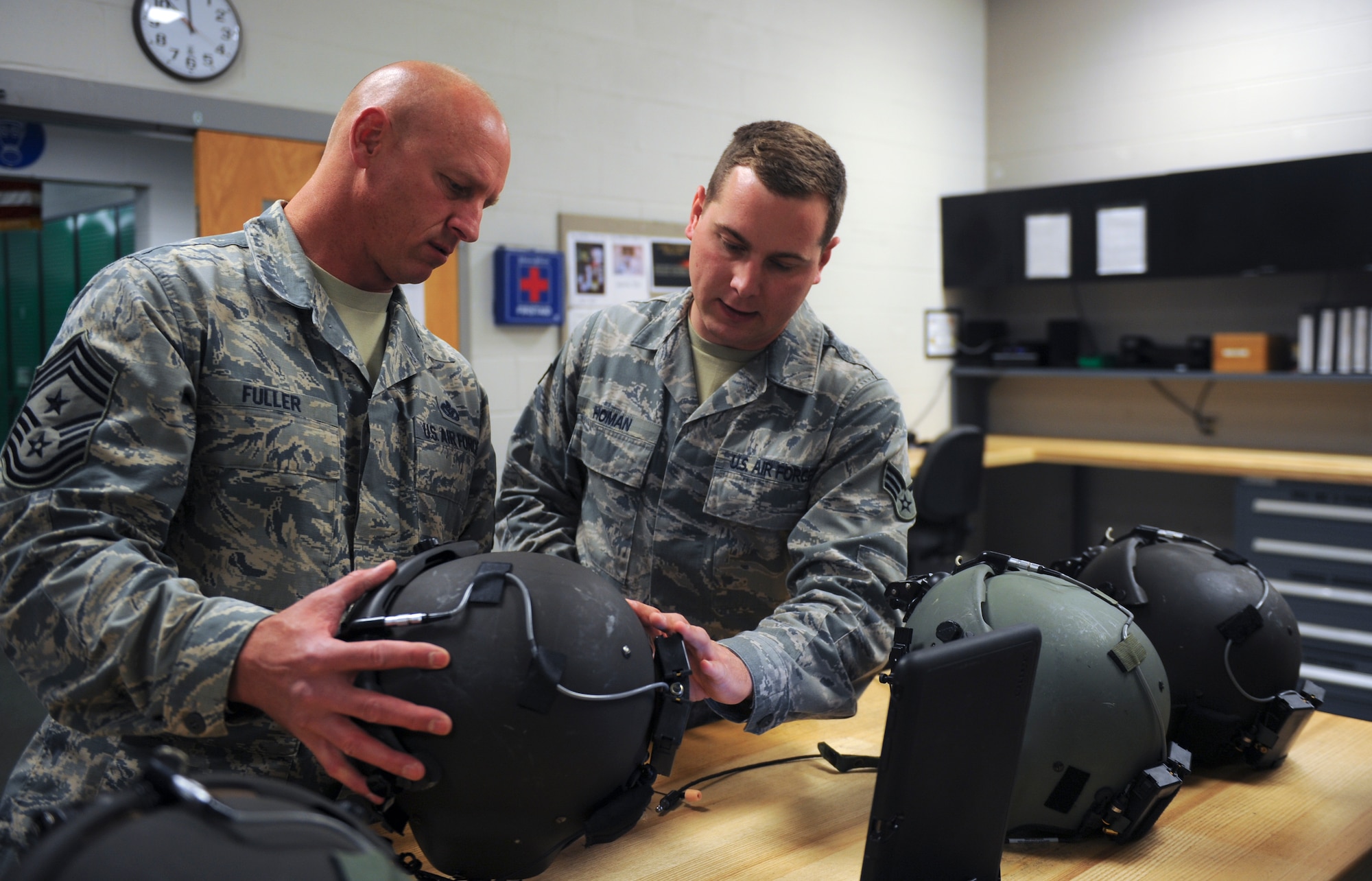 U.S. Air Force Senior Airman Jacob Homan, 347th Operations Support Squadron aircrew flight equipment, sizes Chief Master Sgt. Scott Fuller, Ninth Air Force command chief, for a helmet before a flight at Moody Air Force Base, Ga., April 9, 2014. Fuller had the opportunity to see rescue training in action on an HH-60G Pave Hawk. (U.S. Air Force photo by Senior Airman Olivia Bumpers/Released)