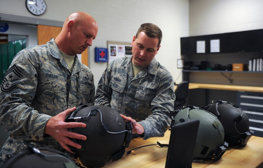 U.S. Air Force Senior Airman Jacob Homan, 347th Operations Support Squadron aircrew flight equipment, sizes Chief Master Sgt. Scott Fuller, Ninth Air Force command chief, for a helmet before a flight at Moody Air Force Base, Ga., April 9, 2014. Fuller had the opportunity to see rescue training in action on an HH-60G Pave Hawk. (U.S. Air Force photo by Senior Airman Olivia Bumpers/Released)