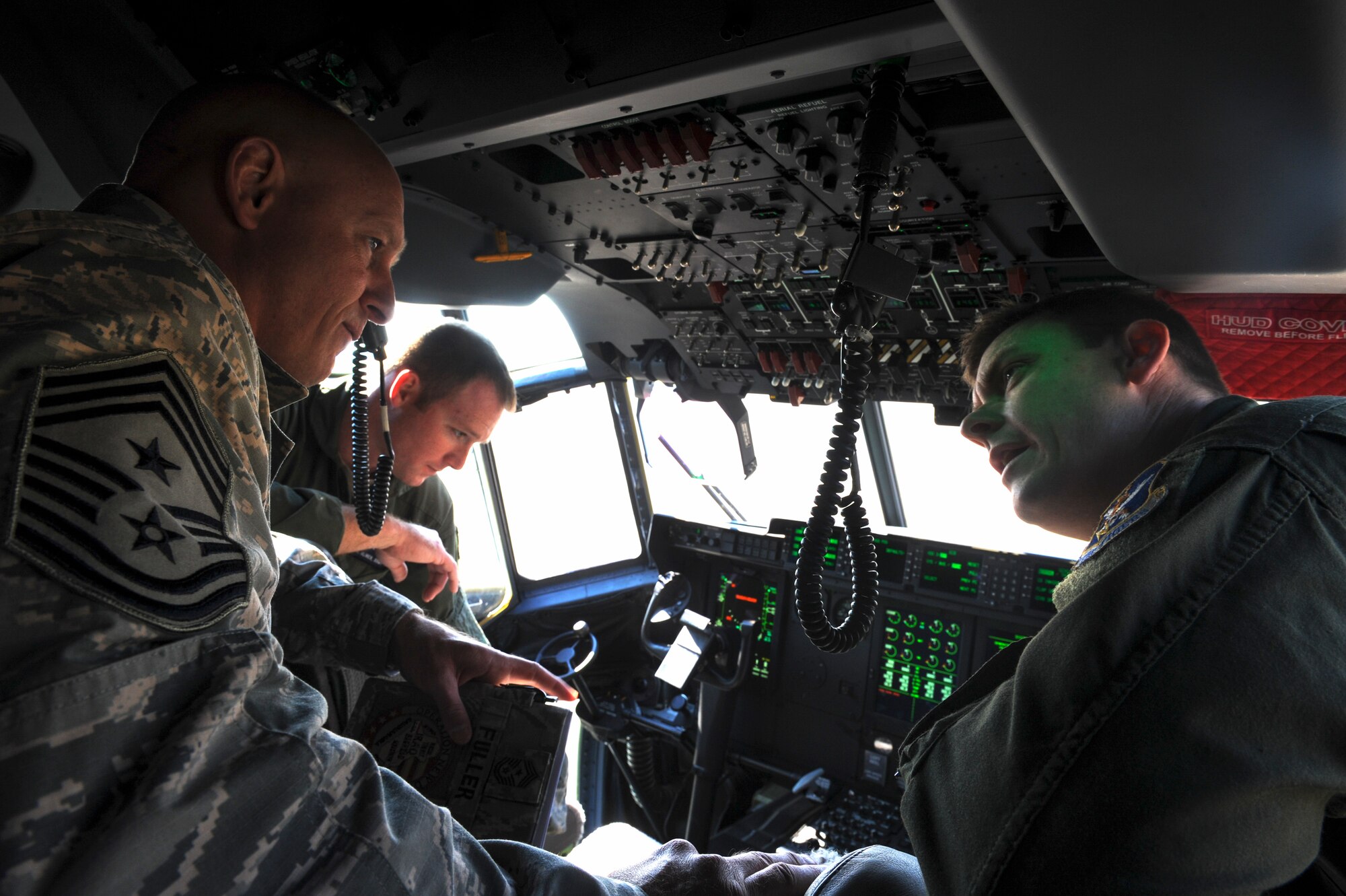 U.S. Air Force Staff Sgt. Brent Slyter (right) 71st Rescue Squadron loadmaster, explains the upgrades on the new HC-130J Combat King II to Chief Master Sgt. Scott Fuller, Ninth Air Force command chief, during a visit at Moody Air Force Base, Ga., April 9, 2014. During his visit, Fuller received a base tour and saw Moody’s mission capabilities firsthand. (U.S. Air Force photo by Senior Airman Olivia Bumpers/Released)