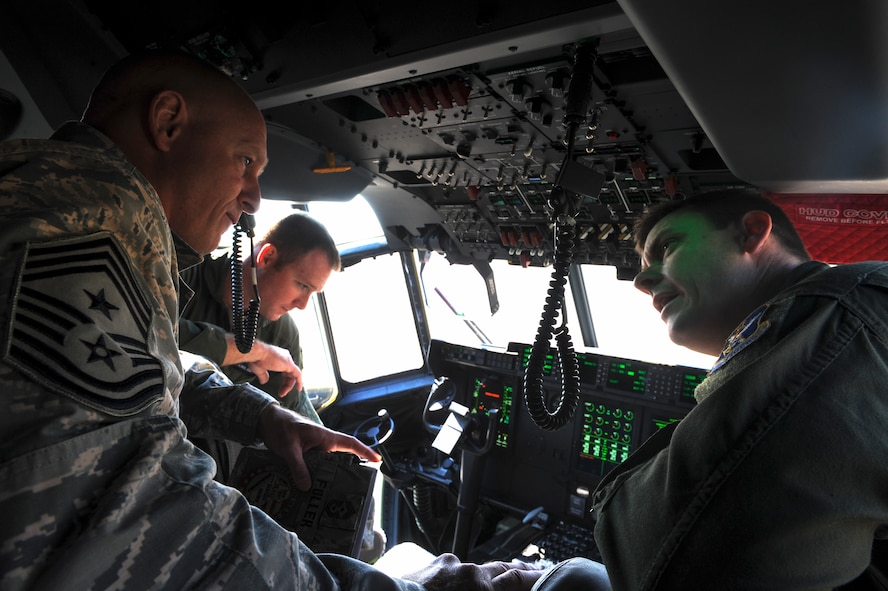 U.S. Air Force Staff Sgt. Brent Slyter (right) 71st Rescue Squadron loadmaster, explains the upgrades on the new HC-130J Combat King II to Chief Master Sgt. Scott Fuller, Ninth Air Force command chief, during a visit at Moody Air Force Base, Ga., April 9, 2014. During his visit, Fuller received a base tour and saw Moody’s mission capabilities firsthand. (U.S. Air Force photo by Senior Airman Olivia Bumpers/Released)