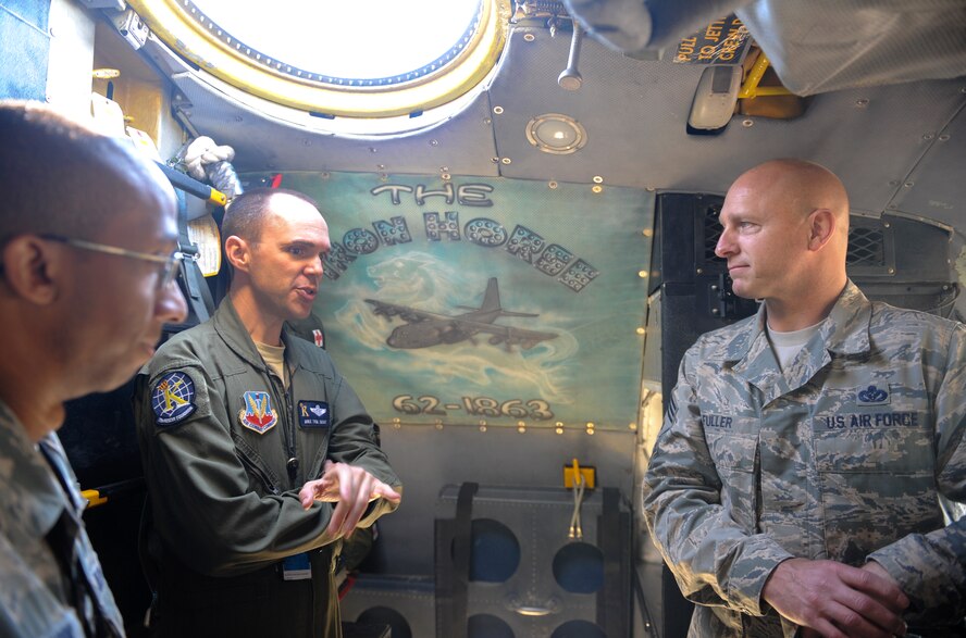 U.S. Air Force Senior Master Sgt. Mike Trim, 71st Rescue Squadron superintendent, speaks to Chief Master Sgt. Scott Fuller, Ninth Air Force command chief, during a visit at Moody Air Force Base, Ga., April 9, 2014. Fuller had the opportunity to see the differences between the legacy HC-130P Combat King and the new HC-130J model. (U.S. Air Force photo by Senior Airman Olivia Bumpers/Released)
