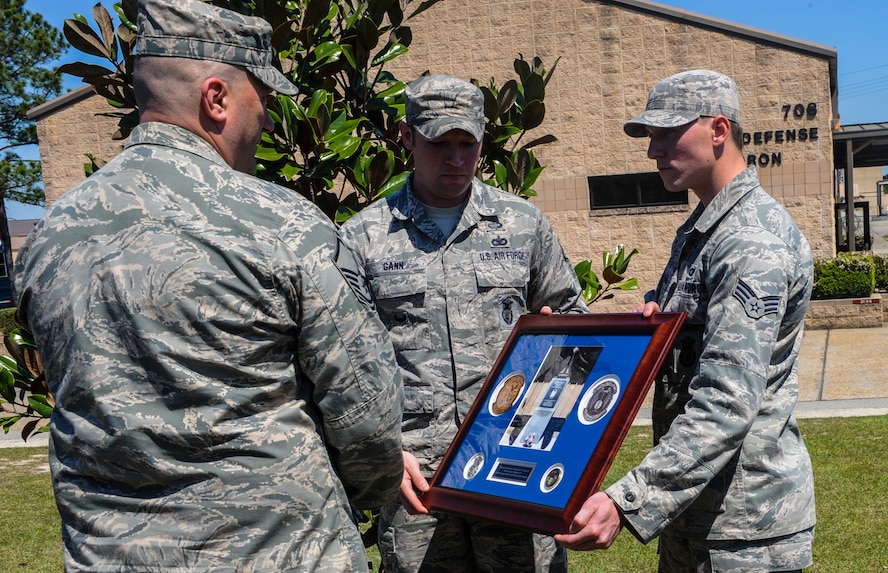 U.S. Air Force Master Sgt. Todd Lobraico Sr., 105th Security Forces Squadron, receives a plaque in remembrance of his son, Staff Sgt. Todd Lobraico Jr., at Moody Air Force Base, Ga., April 10, 2014. Lobraico died Sept. 5, 2013, while deployed to Bagram Airfield, Afghanistan with 823d Base Defense Squadron. (U.S. Air Force photo by Airman 1st Class Alexis Millican/Released)
