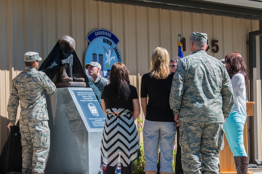 Family members of U.S. Air Force Staff Sgt. Todd Lobraico Jr. watch as a memorial is unveiled in his honor during a dedication ceremony April 10, 2014, at Moody Air Force Base, Ga. Lobraico was assigned to the 105th Security Forces Squadron out of Stewart Air National Guard Base, N.Y., and died Sept. 5, 2013, from wounds sustained when enemy forces attacked his unit with small-arms fire near Bagram Airfield, Afghanistan. (U.S. Air Force photo by Airman 1st Class Ryan Callaghan/Released)