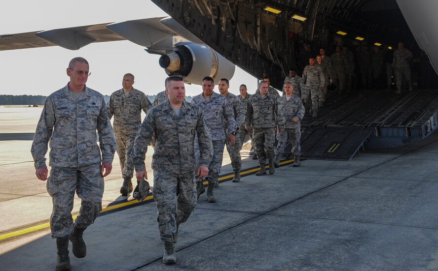 Members of the 105th Security Forces Squadron out of Stewart Air National Guard, N.Y., exit a C-17 Globemaster III April 10, 2014, at Moody Air Force Base, Ga. The Airmen traveled to Moody to attend a memorial dedication ceremony in honor of Staff Sgt. Todd Lobraico Jr., a member of their unit who died Sept. 5, 2013, from wounds sustained when enemy forces attacked his unit with small-arms fire near Bagram Airfield, Afghanistan. (U.S. Air Force photo by Airman 1st Class Alexis Millican/Released)  