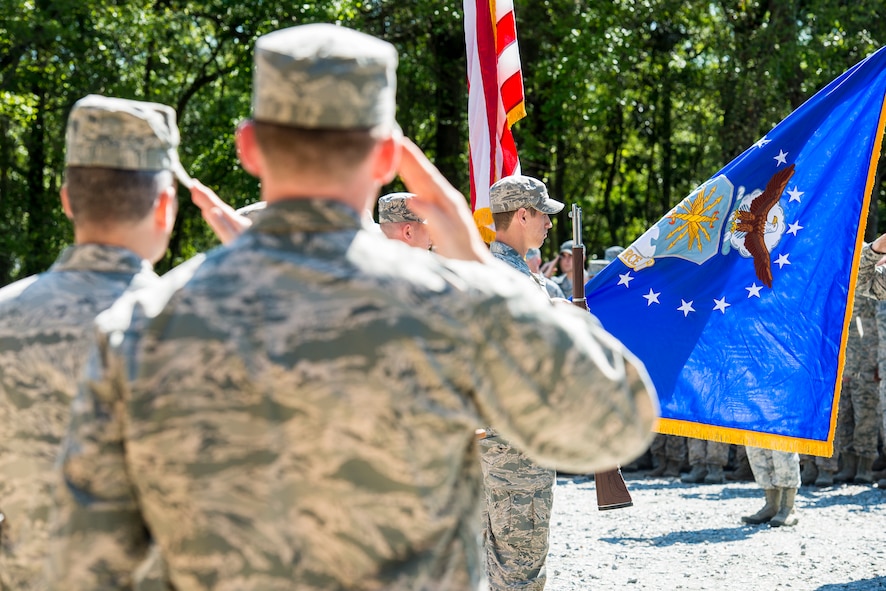 Airmen salute the flag during the singing of the national anthem at a memorial dedication ceremony in honor of Staff Sgt. Todd Lobraico Jr., at Moody Air Force Base, Ga., April 10, 2014. Lobraico was assigned to the 105th Security Forces Squadron out of Stewart Air National Guard Base, N.Y., and died Sept. 5, 2013, from wounds sustained when enemy forces attacked his unit with small-arms fire near Bagram Airfield, Afghanistan. (U.S. Air Force photo by Airman 1st Class Ryan Callaghan/Released)