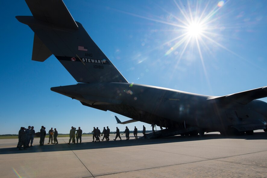 Members of the 105th Security Forces Squadron from Stewart Air National Guard Base, N.Y., exit a C-17 Globemaster III April 10, 2014, at Moody Air Force Base, Ga. The Airmen traveled to Moody to attend a memorial dedication ceremony in honor of Staff Sgt. Todd Lobraico Jr., a member of their unit who died Sept. 5, 2013, from wounds sustained when enemy forces attacked his unit with small-arms fire near Bagram Airfield, Afghanistan. (U.S. Air Force photo by Airman 1st Class Ryan Callaghan/Released)