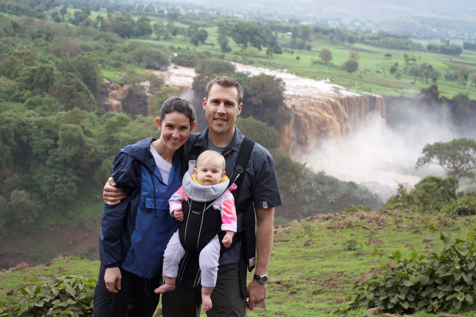 Capt. Amy West, an individual mobilization augmentee assigned to the 56th Fighter Wing Public Affairs office, poses with her husband and son July 27, 2013, in front of the Blue Nile waterfall in Ethiopia. West works as a civilian for the U.S. Embassy in Ethiopia as a community liaison office coordinator. (Courtesy photo)