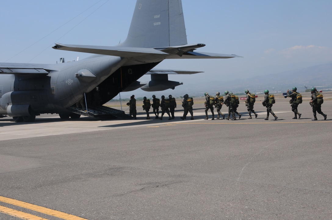 Honduran 2nd Combat Airborne Infantry Battalion paratroopers board a C-130 Hercules aircraft to perform a joint airborne operations training jump with the 7th Special Forces Group at Soto Cano Air Base, Honduras on April 3, 2014.  The 1,500 foot static line jump allowed members from both nations to retain currency, while also strengthening the relationship between the U.S. and Honduran forces.  (Photo by U. S. Air National Guard Capt. Steven Stubbs)